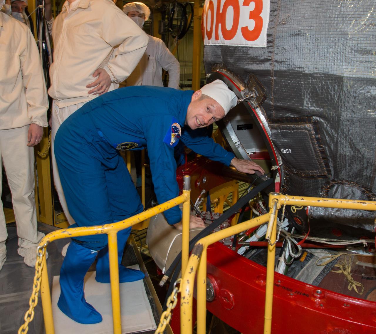 2014-03-14-10-17-15-2[1] In the Integration Facility at the Baikonur Cosmodrome in Kazakhstan, Expedition 39/40 Flight Engineer Steve Swanson of NASA enters his Soyuz TMA-12M spacecraft during a “fit check” dress rehearsal exercise March 14 that is part of the crew’s final training. Swanson, Soyuz Commander Alexander Skvortsov of the Russian Federal Space Agency (Roscosmos) and Flight Engineer Oleg Artemyev of Roscosmos are scheduled to launch to the International Space Station March 26 (Kazakh time) for the start of a six-month mission.  NASA/Victor Zelentsov 