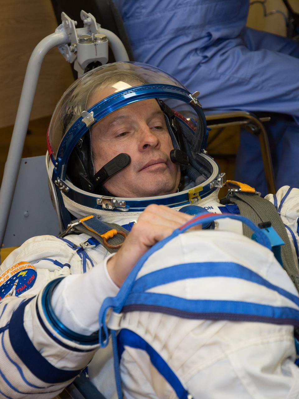 2014-03-14-12-55-32[1] In the Integration Facility at the Baikonur Cosmodrome in Kazakhstan, Expedition 39/40 Flight Engineer Steve Swanson of NASA undergoes a pressure check for his Russian Sokol launch and entry suit during a “fit check” dress rehearsal March 14 that is part of the crew’s training. Swanson, Soyuz Commander Alexander Skvortsov of the Russian Federal Space Agency (Roscosmos) and Flight Engineer Oleg Artemyev of Roscosmos are scheduled to launch to the International Space Station March 26 (Kazakh time) for the start of a six-month mission.  NASA/Victor Zelentsov 