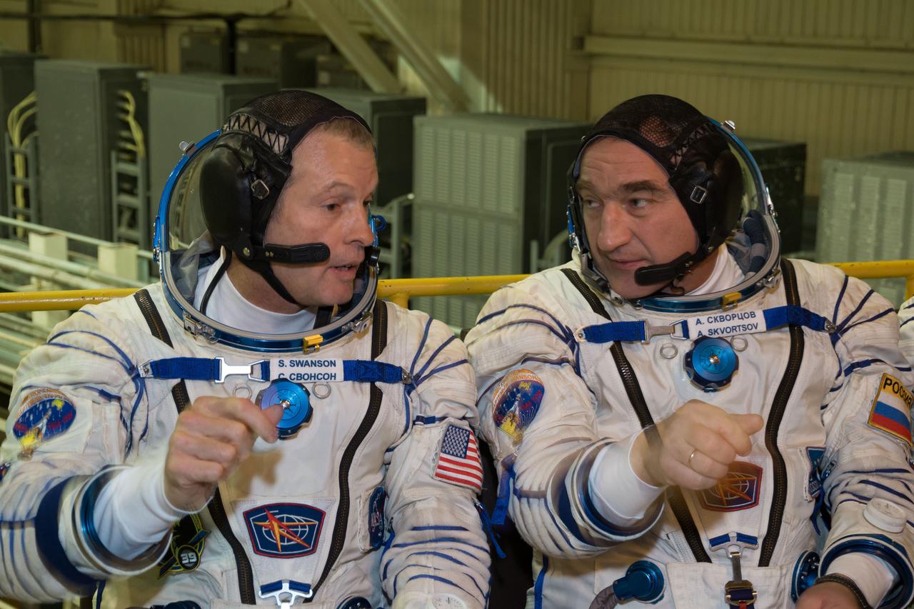 2014-03-14-13-08-55-3[1] In the Integration Facility at the Baikonur Cosmodrome in Kazakhstan, Expedition 39/40 Flight Engineer Steve Swanson of NASA (left) shares a word with Soyuz Commander Alexander Skvortsov of the Russian Federal Space Agency (Roscosmos; right) during a “fit check” dress rehearsal March 14 that is part of the crew’s training. Swanson, Skvortsov and Flight Engineer Oleg Artemyev of Roscosmos are scheduled to launch to the International Space Station March 26 (Kazakh time) for the start of a six-month mission.  NASA/Victor Zelentsov 