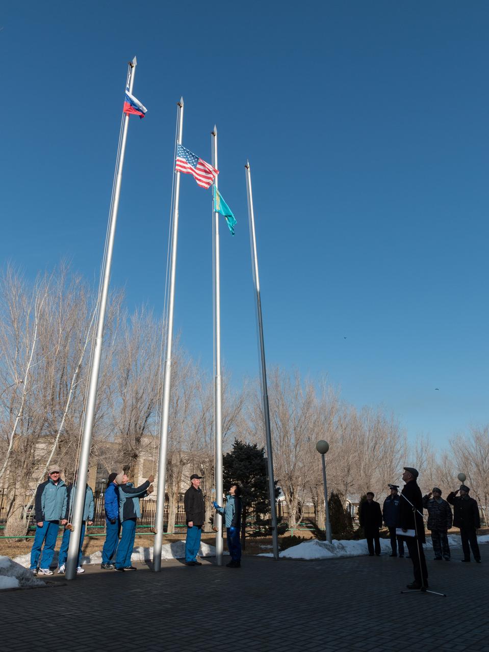 2014-03-15-11-04-32-3[1] At the Cosmonaut Hotel crew quarters in Baikonur, Kazakhstan, the flags of Russia, the United States and Kazakhstan fly high March 15 after a flag-raising ceremony that is part of traditional pre-launch activities. Expedition 39/40 Flight Engineer Steve Swanson of NASA, Soyuz Commander Alexander Skvortsov of the Russian Federal Space Agency (Roscosmos) and Flight Engineer Oleg Artemyev of Roscosmos are scheduled to launch to the International Space Station March 26 (Kazakh time) for the start of a six-month mission.  NASA/Victor Zelentsov 