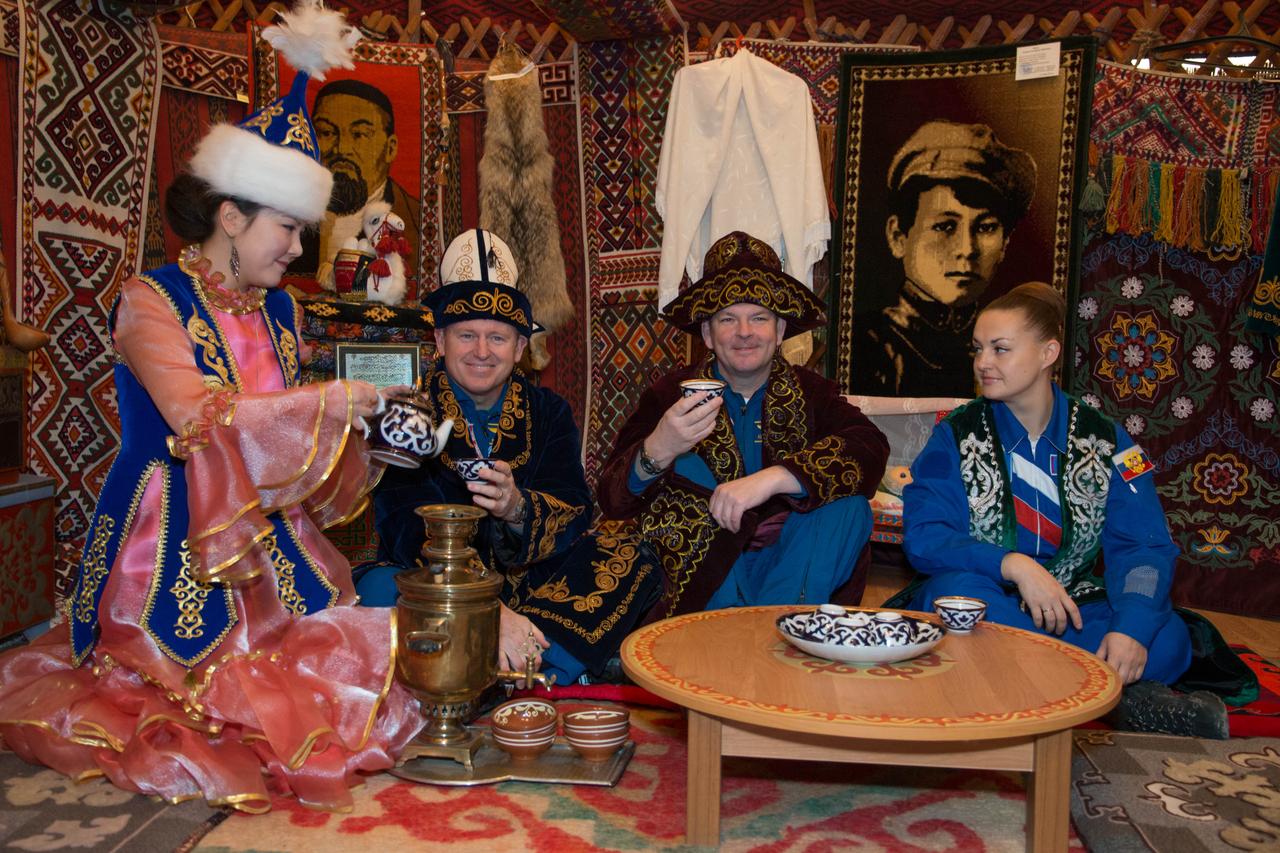 2014-03-15-13-00-13[1] Wearing native garb, the Expedition 39/40 backup crewmembers partake in traditional ceremonies with a Kazakh host March 15 in Baikonur, Kazakhstan as pre-flight training for them and their prime crewmember colleagues continues. Barry Wilmore of NASA (second from left), Alexander Samokutyaev of the Russian Federal Space Agency (Roscosmos; second from right) and Elena Serova of Roscosmos (far right) are the backups to Expedition 39/40 Flight Engineer Steve Swanson of NASA, Soyuz Commander Alexander Skvortsov of Roscosmos and Flight Engineer Oleg Artemyev of Roscosmos, who are scheduled to launch to the International Space Station March 26 (Kazakh time) for the start of a six-month mission.  NASA/Victor Zelentsov 