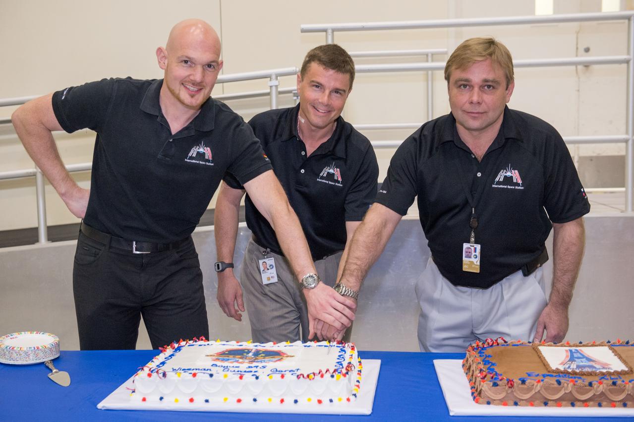 PHOTO DATE: 3-19-14 LOCATION: Bldg. 5 - High Bay SUBJECT: Soyuz 39 crew members (Expedition 41), Maxim Suraev, Greg Wiseman, Alexander Gerst during SSTF Cake Cutting Ceremony marking the end of their training. PHOTOGRAPHER: Lauren Harnett