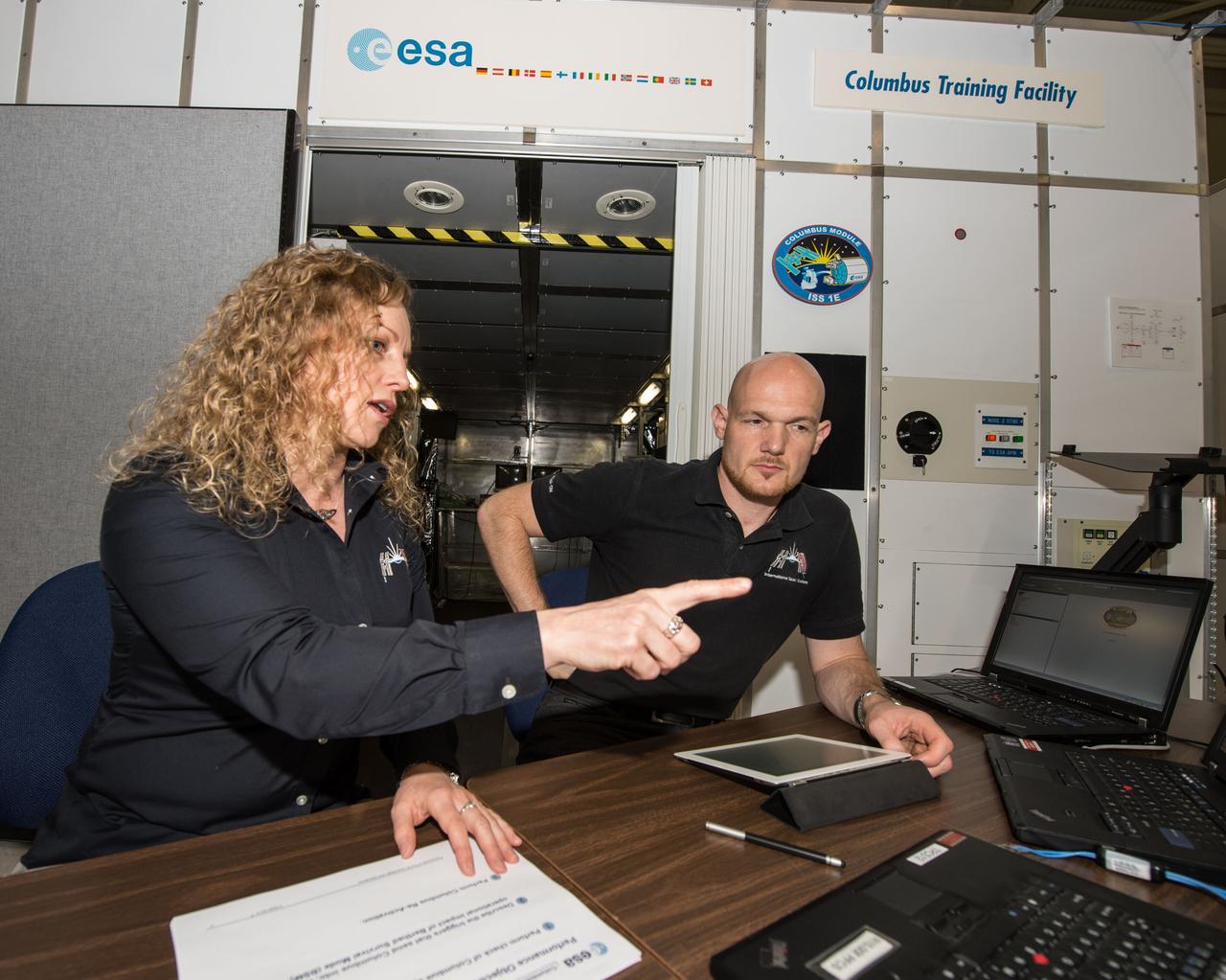 PHOTO DATE: 03/28/14 LOCATION: B5 SSTF SUBJECT: Michaela Benda training ESA astronaut and Expedition 41 crew member during Columbus module training PHOTOGRAPHER: GEESEMAN