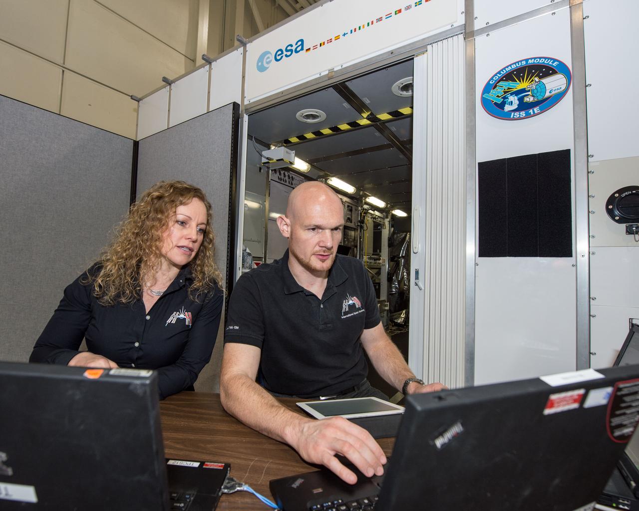 PHOTO DATE: 03/28/14 LOCATION: B5 SSTF SUBJECT: Michaela Benda training ESA astronaut and Expedition 41 crew member during Columbus module training PHOTOGRAPHER: GEESEMAN