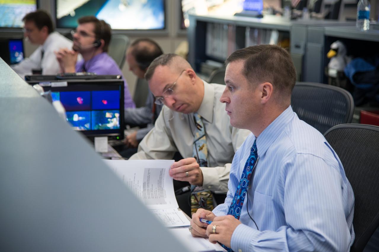 Expedition 39 flight controllers on console during SpaceX cargo rendezvous and grappling. Flight Director: Matt Abbott. Capcoms: Jack Fischer and Randy Bresnik. Photo Date: April 20, 2014. Location: Building 30 - FCR-1. Photographer: Robert Markowitz