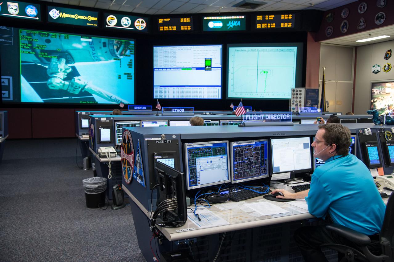 Expedition 39 flight controllers on console during SpaceX cargo rendezvous and grappling. Flight Director: Matt Abbott. Capcoms: Jack Fischer and Randy Bresnik. Photo Date: April 20, 2014. Location: Building 30 - FCR-1. Photographer: Robert Markowitz