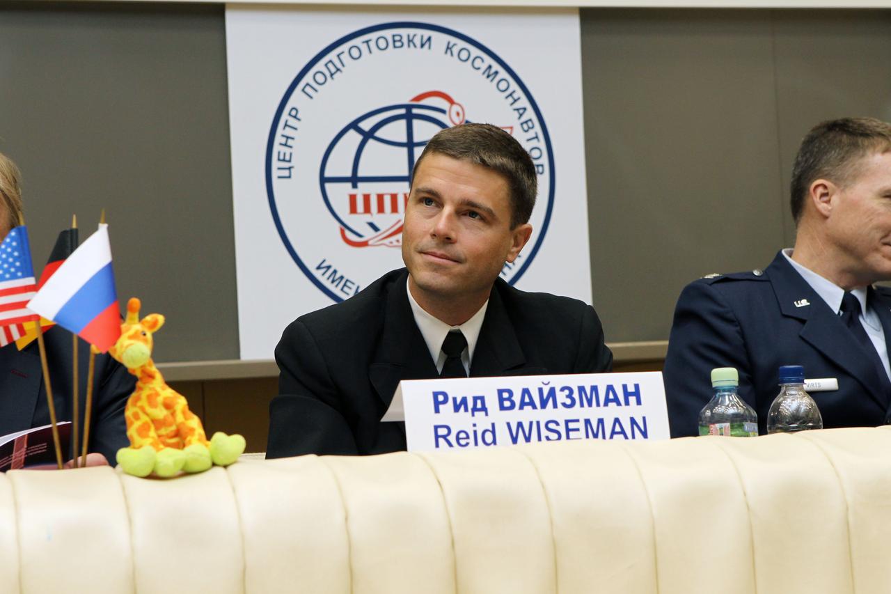 0704:  At the Gagarin Cosmonaut Training Center in Star City, Russia, Expedition 40/41 Flight Engineer Reid Wiseman of NASA listens to a reporter’s question May 8 during a pre-launch news conference. Near him is a toy giraffe belonging to his daughter that will fly as a “zero-G” mascot above the heads of the crew in the Soyuz TMA-13M spacecraft when Wiseman, Flight Engineer Alexander Gerst of the European Space Agency and Soyuz Commander Max Suraev of the Russian Federal Space Agency (Roscosmos) launch May 29, Kazakh time, from the Baikonur Cosmodrome in Kazakhstan for a 5 ½ month mission on the International Space Station.   NASA/Stephanie Stoll 