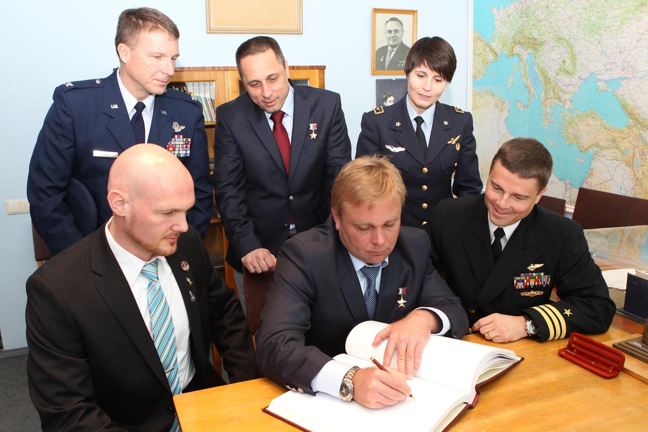 0829:  At the Gagarin Cosmonaut Training Center in Star City, Russia, Expedition 40/41 Soyuz Commander Max Suraev of the Russian Federal Space Agency (Roscosmos, front row and center), signs a ceremonial book during a tour of the Gagarin Museum May 8 as his crewmates and their backups look on. Also pictured are prime crewmember Alexander Gerst of the European Space Agency (front row, left) and NASA’s Reid Wiseman (front row, right) and backup crewmembers Terry Virts of NASA (back row, left), Anton Shkaplerov of Roscosmos (back row, center) and Samantha Cristoforetti of the European Space Agency (back row, right). Gerst, Suraev and Wiseman of NASA are preparing for launch May 29, Kazakh time, from the Baikonur Cosmodrome in Kazakhstan on the Soyuz TMA-13M spacecraft for a 5 ½ month mission on the International Space Station.  NASA/Stephanie Stoll 