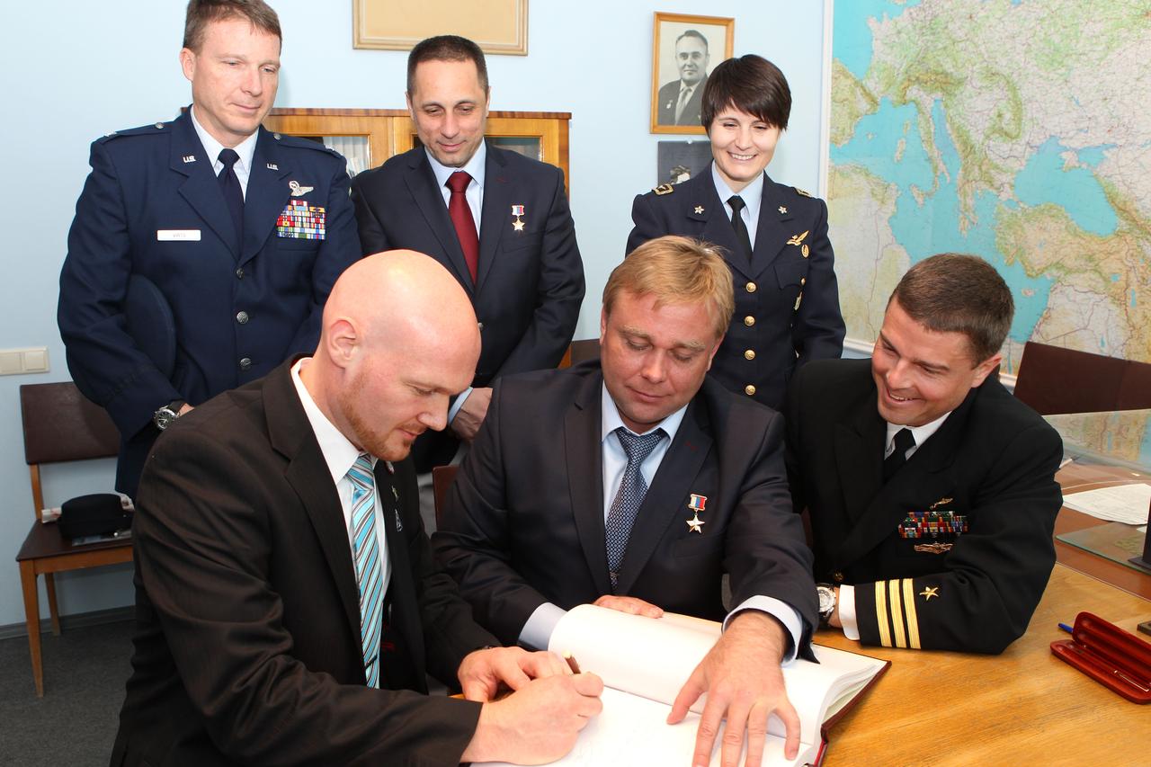 0856:  At the Gagarin Cosmonaut Training Center in Star City, Russia, Expedition 40/41 Flight Engineer Alexander Gerst of the European Space Agency (front row, left) signs a ceremonial book during a tour of the Gagarin Museum May 8 as his crewmates and their backups look on. Also pictured are Soyuz Commander Max Suraev of the Russian Federal Space Agency (Roscosmos, front row, center) and Flight Engineer Reid Wiseman of NASA (front row, right) and backup crewmembers Terry Virts of NASA (back row, left), Anton Shkaplerov of Roscosmos (back row, center) and Samantha Cristoforetti of the European Space Agency (back row, right). Wiseman, Gerst, and Suraev are preparing for launch May 29, Kazakh time, from the Baikonur Cosmodrome in Kazakhstan on the Soyuz TMA-13M spacecraft for a 5 ½ month mission on the International Space Station.  NASA/Stephanie Stoll 