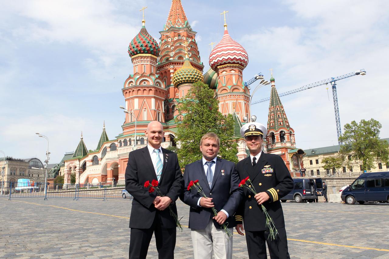 1034:  In front of St. Basil’s Cathedral in Moscow’s Red Square, Expedition 40/41 Flight Engineer Alexander Gerst of the European Space Agency (left), Soyuz Commander Max Suraev of the Russian Federal Space Agency (Roscosmos, center) and Flight Engineer Reid Wiseman of NASA (right) pose for pictures May 8 before laying flowers at the Kremlin Wall where Russian space icons are interred. The trio is preparing for launch May 29, Kazakh time, in the Soyuz TMA-13M spacecraft from the Baikonur Cosmodrome in Kazakhstan for a 5 ½ month mission on the International Space Station.  NASA/Stephanie Stoll 