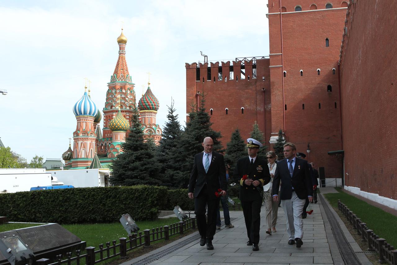 1052: At the Kremlin Wall in Moscow’s Red Square, Expedition 40/41 Flight Engineer Alexander Gerst of the European Space Agency (left), Soyuz Commander Max Suraev of the Russian Federal Space Agency (Roscosmos, center) and Flight Engineer Reid Wiseman of NASA (right) prepare to lay flowers May 8 where Russian space icons are interred. The trio is preparing for launch May 29, Kazakh time, in the Soyuz TMA-13M spacecraft from the Baikonur Cosmodrome in Kazakhstan for a 5 ½ month mission on the International Space Station. NASA/Stephanie Stoll