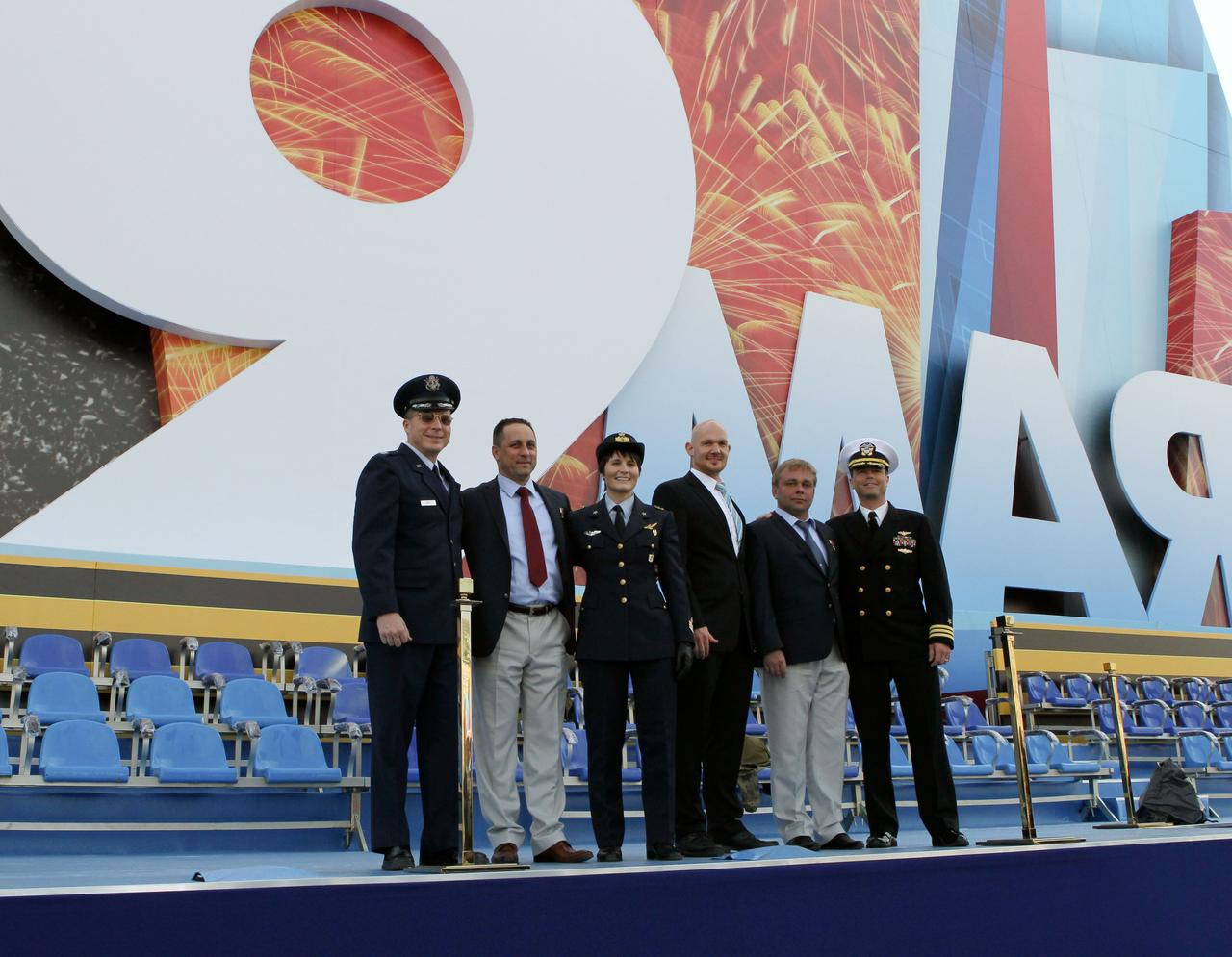 1183A:  At Red Square in Moscow, the Expedition 40/41 backup and prime crewmembers pose for pictures on a stage May 8 that is set up for a concert May 9 to celebrate the  Russian holiday of Victory Day May 9. From left to right are backup crewmembers Terry Virts of NASA, Anton Shkaplerov of the Russian Federal Space Agency (Roscosmos), Samantha Cristoforetti of the European Space Agency, and prime crewmembers Alexander Gerst of the European Space Agency, Max Suraev of Roscosmos and Reid Wiseman of NASA. Gerst, Suraev and Wiseman are preparing for launch May 29, Kazakh time, in the Soyuz TMA-13M spacecraft from the Baikonur Cosmodrome in Kazakhstan for a 5 ½ month mission on the International Space Station.  NASA/Stephanie Stoll 