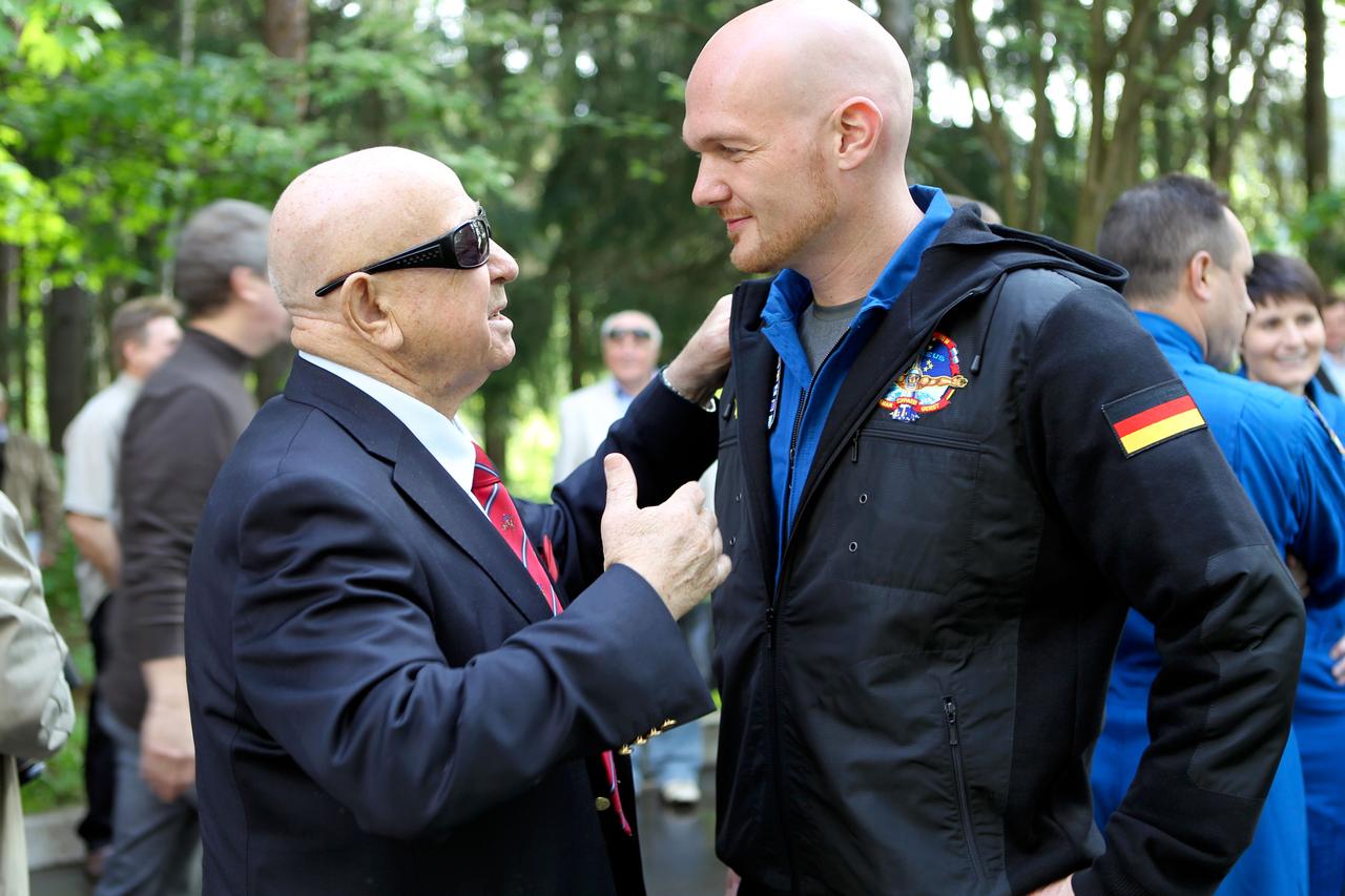 1421:  At the Gagarin Cosmonaut Training Center in Star City, Russia, Expedition 40/41 Flight Engineer Alexander Gerst of the European Space Agency (right) shares a special moment with former cosmonaut Alexey Leonov, the first human to walk in space (left), during ceremonies May 15 to mark the crew’s departure for their launch site at the Baikonur Cosmodrome in Kazakhstan for final pre-launch training. Gerst, NASA Flight Engineer Reid Wiseman and Soyuz Commander Max Suraev of the Russian Federal Space Agency (Roscosmos) will launch on May 29, Kazakh time, in the Soyuz TMA-13M spacecraft from Baikonur for a 5 ½ month mission on the International Space Station.  NASA/Stephanie Stoll 