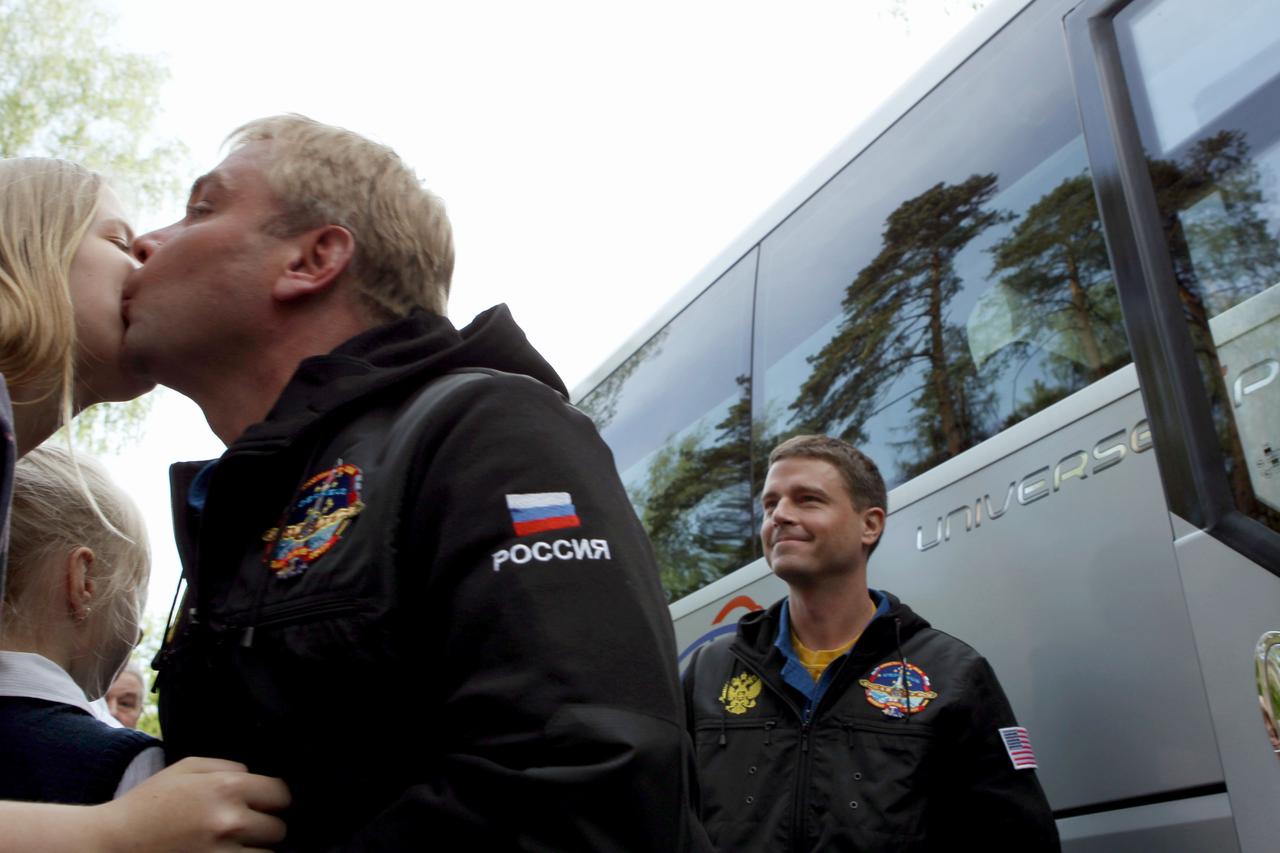 1602A:  With his crewmate, NASA Flight Engineer Reid Wiseman (right) looking on, Expedition 40/41 Soyuz Commander Max Suraev of the Russian Federal Space Agency (Roscosmos) kisses his wife goodbye at the Gagarin Cosmonaut Training Center in Star City, Russia May 15 as they depart for their launch site at the Baikonur Cosmodrome in Kazakhstan for final pre-launch training. Suraev, Wiseman and Alexander Gerst of the European Space Agency will launch on May 29, Kazakh time, in the Soyuz TMA-13M spacecraft from Baikonur for a 5 ½ month mission on the International Space Station.  NASA/Stephanie Stoll 