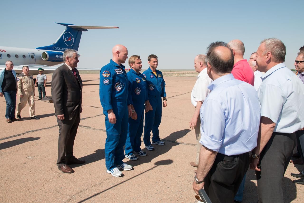 16-19-20-3:  Expedition 40/41 Flight Engineer Alexander Gerst of the European Space Agency (left), Soyuz Commander Max Suraev of the Russian Federal Space Agency (Roscosmos, center) and NASA Flight Engineer Reid Wiseman (right) are greeted by Russian space officials May 15 at the Baikonur Cosmodrome in Kazakhstan where the crew flew to for final pre-launch training. Just behind the crew is former cosmonaut Valery Korzun, now the Deputy Head of the Gagarin Cosmonaut Training Center in Star City, Russia. Gerst, Suraev and Wiseman will launch May 29, Kazakh time, in their Soyuz TMA-13M spacecraft from Baikonur for a 5 ½ month mission on the International Space Station.  NASA/Victor Zelentsov 
