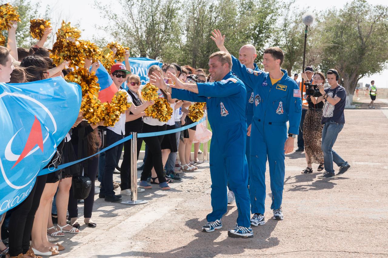 15-16-21-23:  Expedition 40/41 Soyuz Commander Max Suraev of the Russian Federal Space Agency (Roscosmos, left), Flight Engineer Alexander Gerst of the European Space Agency (center) and NASA Flight Engineer Reid Wiseman (right) are greeted by local well-wishers at the Baikonur Cosmodrome in Kazakhstan May 15 as they arrived for final pre-launch training. Gerst, Suraev and Wiseman will launch May 29, Kazakh time, in their Soyuz TMA-13M spacecraft from Baikonur for a 5 ½ month mission on the International Space Station.  NASA/Victor Zelentsov 
