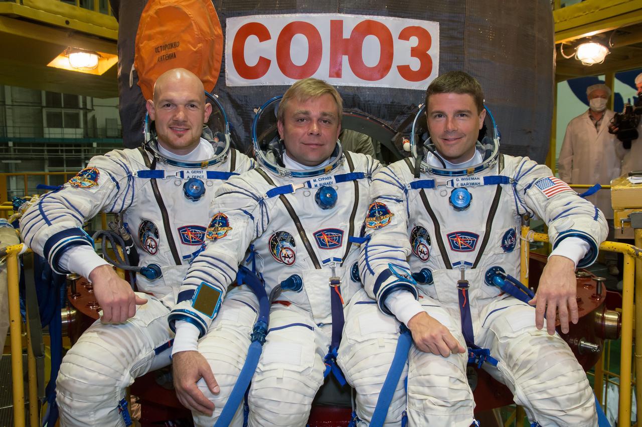 13-04-23:  At the Baikonur Cosmodrome in Kazakhstan, Expedition 40/41 Flight Engineer Alexander Gerst of the European Space Agency (left), Soyuz Commander Max Suraev of the Russian Federal Space Agency (Roscosmos, center) and NASA Flight Engineer Reid Wiseman (right) pose for pictures in their Russian Sokol launch and entry suits in front of their Soyuz TMA-13M spacecraft during a dress rehearsal “fit check” May 16. The trio will launch from Baikonur on May 29, Kazakh time, for a 5 ½ month mission on the International Space Station.  NASA/Victor Zelentsov 