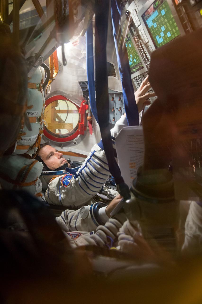 13-52-01-3:  At the Baikonur Cosmodrome in Kazakhstan, Expedition 40/41 Flight Engineer Reid Wiseman of NASA participates in a dress rehearsal “fit check” May 16 inside the Soyuz TMA-13M spacecraft. Wiseman, Soyuz Commander Max Suraev of the Russian Federal Space Agency (Roscosmos) and Flight Engineer Alexander Gerst of the European Space Agency will launch from Baikonur on May 29, Kazakh time, for a 5 ½ month mission on the International Space Station.  NASA/Victor Zelentsov 