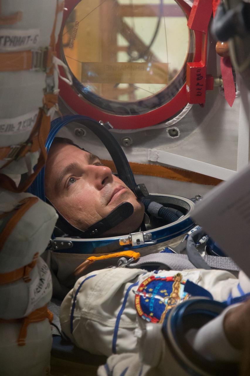 14-02-11:  At the Baikonur Cosmodrome in Kazakhstan, Expedition 40/41 Flight Engineer Reid Wiseman of NASA participates in a dress rehearsal “fit check” May 16 inside the Soyuz TMA-13M spacecraft. Wiseman, Soyuz Commander Max Suraev of the Russian Federal Space Agency (Roscosmos) and Flight Engineer Alexander Gerst of the European Space Agency will launch from Baikonur on May 29, Kazakh time, for a 5 ½ month mission on the International Space Station.  NASA/Victor Zelentsov 