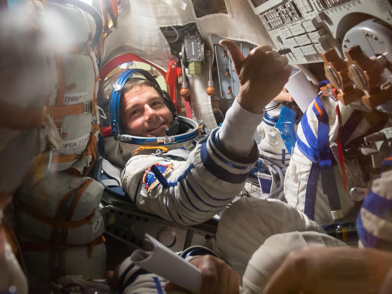 14-04-43-5: At the Baikonur Cosmodrome in Kazakhstan, Expedition 40/41 Flight Engineer Reid Wiseman of NASA offers a “thumbs up” as he participates in a dress rehearsal “fit check” May 16 inside the Soyuz TMA-13M spacecraft. Wiseman, Soyuz Commander Max Suraev of the Russian Federal Space Agency (Roscosmos) and Flight Engineer Alexander Gerst of the European Space Agency will launch from Baikonur on May 29, Kazakh time, for a 5 ½ month mission on the International Space Station. NASA/Victor Zelentsov