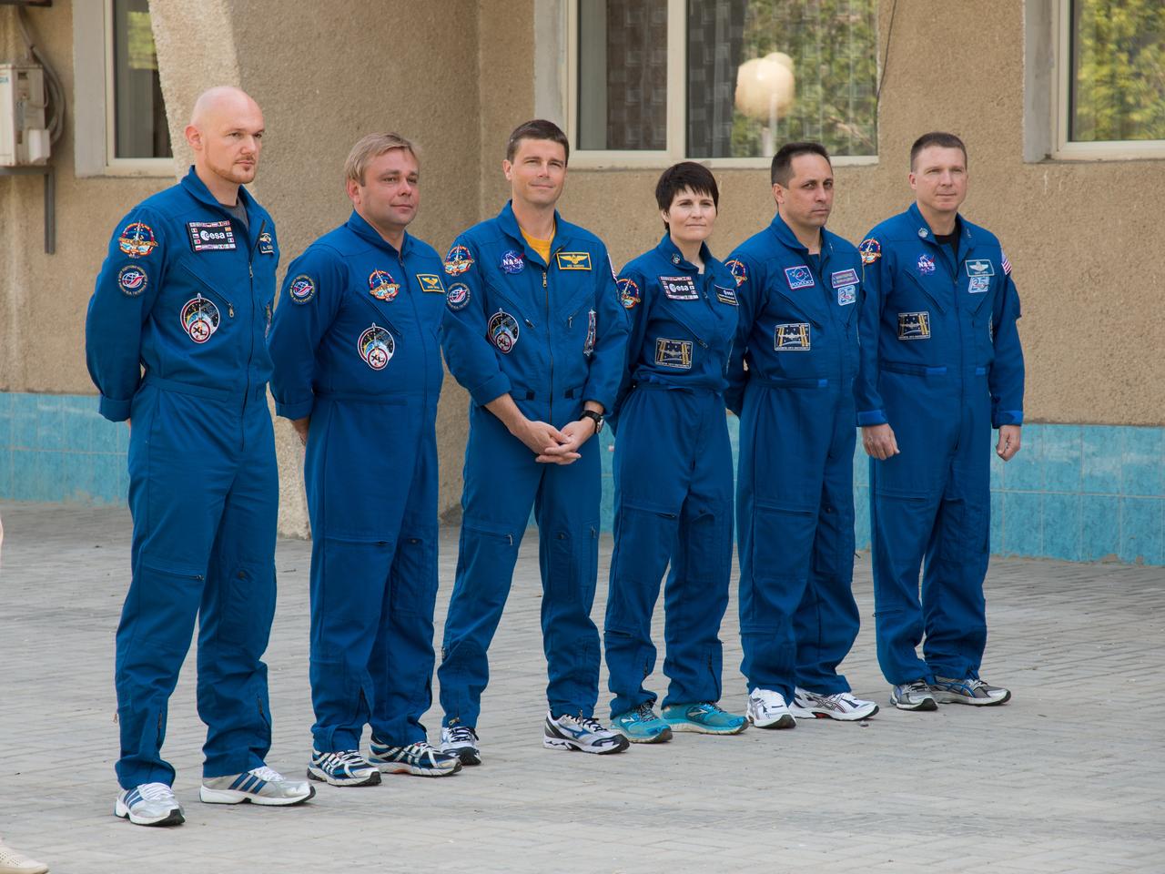 11-07-03:  At the Cosmonaut Hotel crew quarters in Baikonur, Kazakhstan, the Expedition 40/41 prime and backup crewmembers pose for pictures after raising the flags of Russia, the United States, Germany and Kazakhstan during traditional ceremonies May 17. From left to right are prime crewmembers Alexander Gerst of the European Space Agency, Max Suraev of the Russian Federal Space Agency (Roscosmos), Reid Wiseman of NASA and backup crewmembers Samantha Cristoforetti of the European Space Agency. Anton Shkaplerov of Roscosmos and NASA’s Terry Virts. Wiseman, Suraev and Gerst will launch from Baikonur on May 29, Kazakh time, on the Soyuz TMA-13M spacecraft for a 5 ½ month mission on the International Space Station.  NASA/Victor Zelentsov 