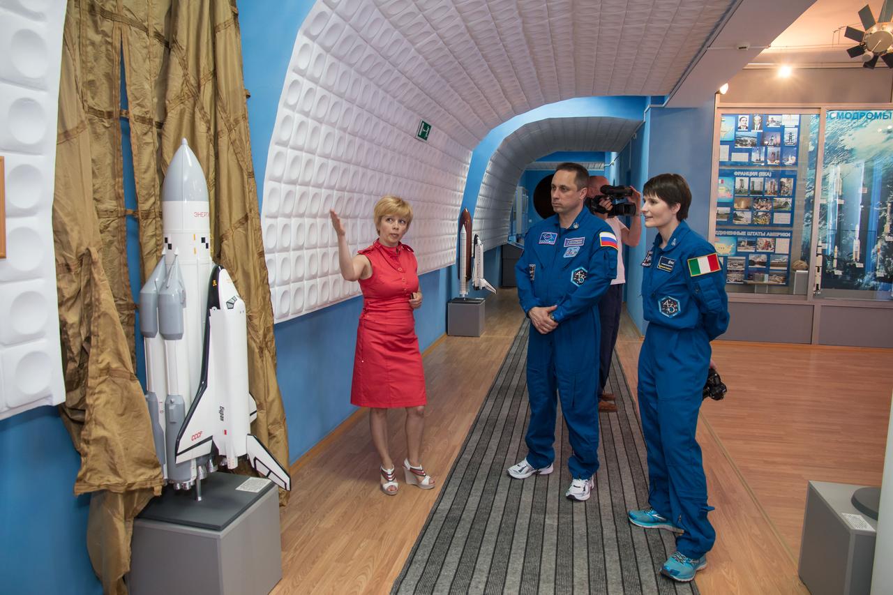 13-11-08-2: In the history museum at the Baikonur Cosmodrome in Kazakhstan, Expedition 40/41 backup crewmembers Anton Shkaplerov of the Russian Federal Space Agency (Roscosmos, center) and Samantha Cristoforetti of the European Space Agency (right) learn about the now-defunct Russian Buran space shuttle during a tour of the facility May 17. Shkaplerov, Cristoforetti and Terry Virts of NASA are backing up the prime crew, Flight Engineer Alexander Gerst of the European Space Agency, Soyuz Commander Max Suraev of the Russian Federal Space Agency (Roscosmos) and NASA Flight Engineer Reid Wiseman, who will launch from Baikonur on May 29, Kazakh time, for a 5 ½ month mission on the International Space Station. NASA/Victor Zelentsov