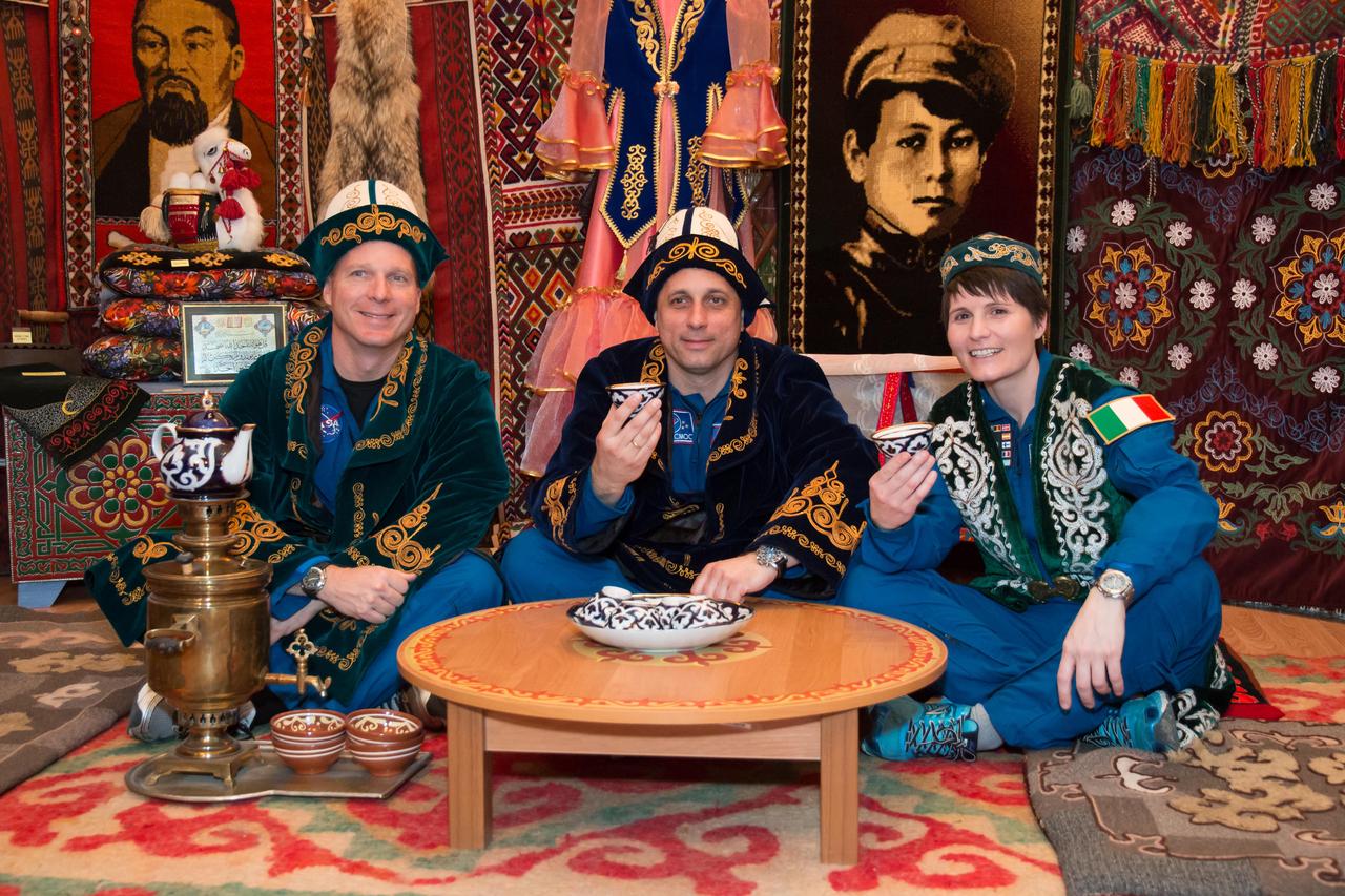 13-43-56-2: In the town of Baikonur, Kazakhstan, Expedition 40/41 backup crewmembers Terry Virts of NASA (left), Anton Shkaplerov of the Russian Federal Space Agency (Roscosmos, center) and Samantha Cristoforetti of the European Space Agency (right) partake in a traditional Kazakh ceremony May 17 in a “yurt”, or tent, during a tour of the community. The trio is backing up the prime crew, Flight Engineer Alexander Gerst of the European Space Agency, Soyuz Commander Max Suraev of the Russian Federal Space Agency (Roscosmos) and NASA Flight Engineer Reid Wiseman, who will launch from Baikonur on May 29, Kazakh time, for a 5 ½ month mission on the International Space Station. NASA/Victor Zelentsov