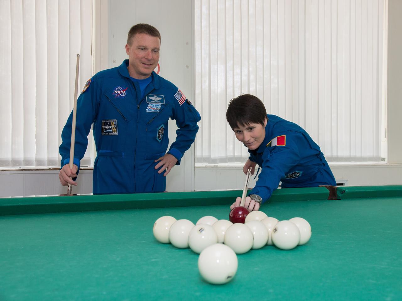 11-47-48:  At the Cosmonaut Hotel crew quarters in Baikonur, Kazakhstan, Expedition 40/41 backup crewmembers Terry Virts of NASA (left) and Samantha Cristoforetti of the European Space Agency (right) try their hand at a game of billiards May 21 as they head into the homestretch of pre-launch training. Virts, Cristoforetti and Anton Shkaplerov of the Russian Federal Space Agency (Roscosmos) are backing up the prime crew, Flight Engineer Alexander Gerst of the European Space Agency, Soyuz Commander Max Suraev of Roscosmos and NASA Flight Engineer Reid Wiseman, who will launch on May 29, Kazakh time, on the Soyuz TMA-13M spacecraft from the Baikonur Cosmodrome for a 5 ½ month mission on the International Space Station.  NASA/Victor Zelentsov 