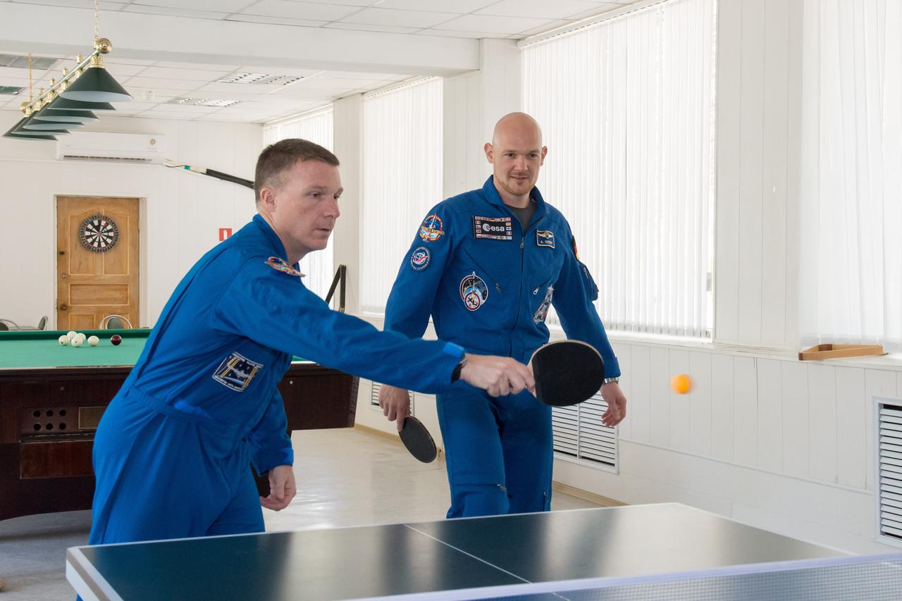 11-52-53:  At the Cosmonaut Hotel crew quarters in Baikonur, Kazakhstan, Expedition 40/41 backup crewmember Terry Virts of NASA (left) and prime crewmember and Flight Engineer Alexander Gerst of the European Space Agency (right) try their hand at a game of Ping-Pong May 21 as they head into the homestretch of their pre-launch training. Gerst, Soyuz Commander Max Suraev of the Russian Federal Space Agency (Roscosmos) and NASA Flight Engineer Reid Wiseman will launch on May 29, Kazakh time, on the Soyuz TMA-13M spacecraft from the Baikonur Cosmodrome for a 5 ½ month mission on the International Space Station.  NASA/Victor Zelentsov 