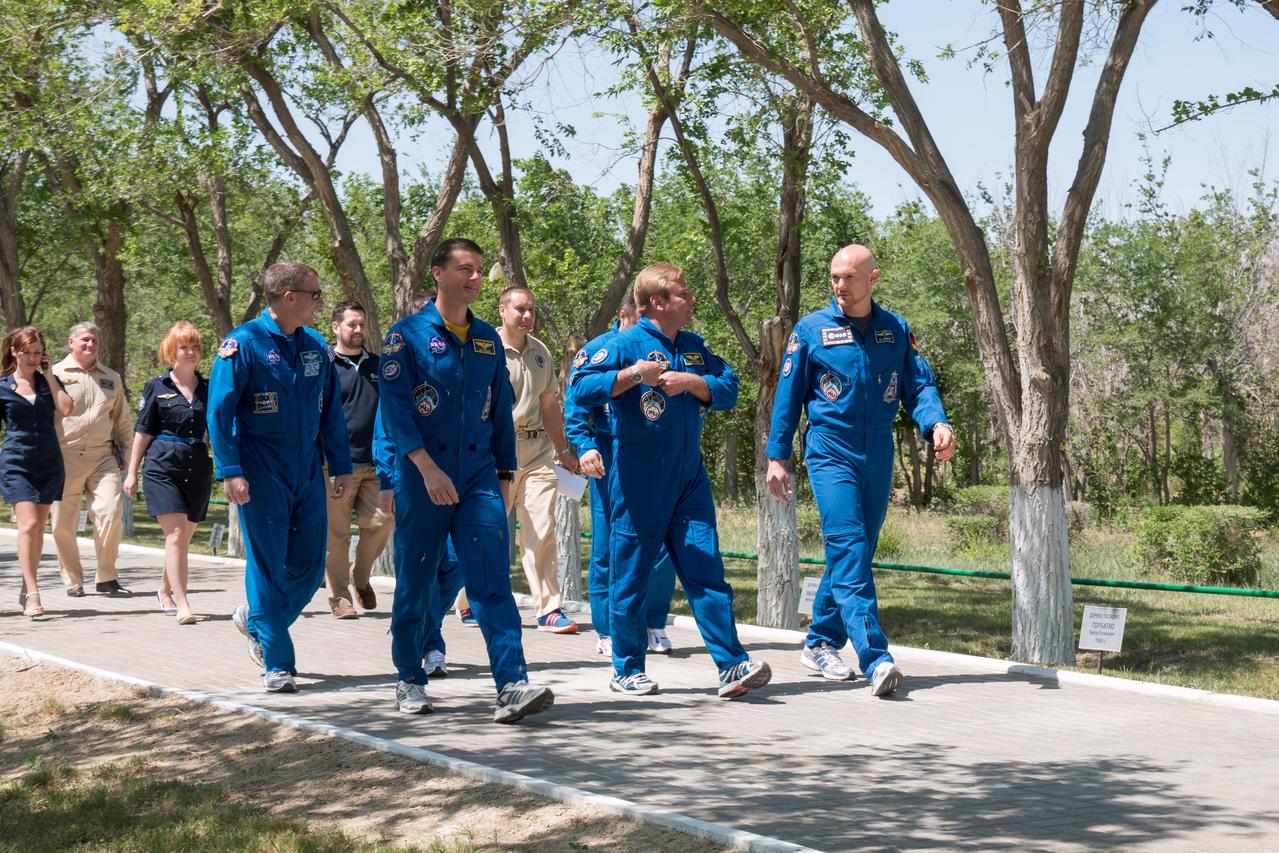 14-05-41-5: At the Cosmonaut Hotel crew quarters in Baikonur, Kazakhstan, Expedition 40/41 Flight Engineer Reid Wiseman of NASA (front row, left), Soyuz Commander Max Suraev of the Russian Federal Space Agency (Roscosmos, front center) and Flight Engineer Alexander Gerst of the European Space Agency (front right) take a stroll down the Walk of Cosmonauts May 21 as part of their traditional pre-launch training ceremonies. Behind Wiseman is backup crewmember Terry Virts of NASA. Wiseman, Suraev and Gerst will launch on May 29, Kazakh time, on the Soyuz TMA-13M spacecraft from the Baikonur Cosmodrome for a 5 ½ month mission on the International Space Station. NASA/Victor Zelentsov