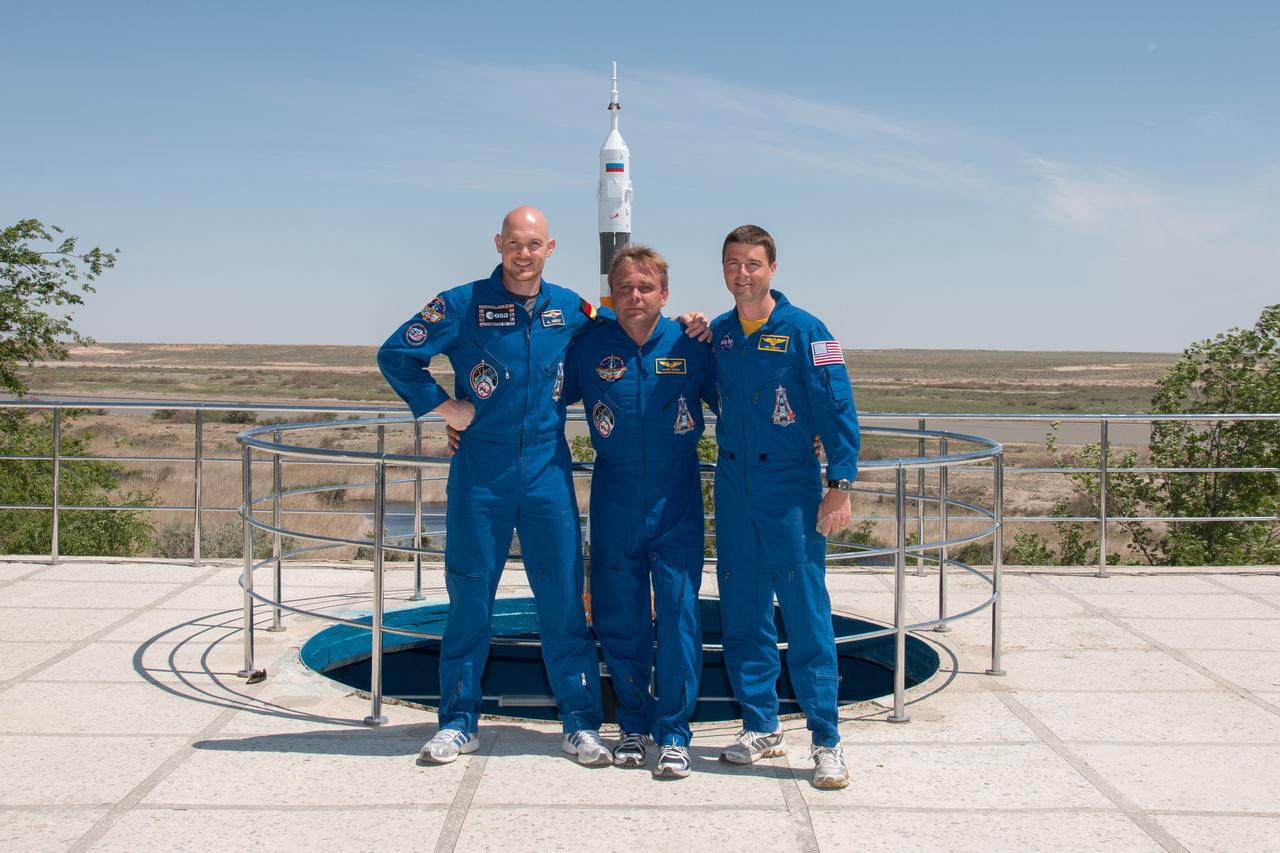 21-14-23-13:  At the Cosmonaut Hotel crew quarters in Baikonur, Kazakhstan, Expedition 40/41 Flight Engineer Alexander Gerst of the European Space Agency (left), Soyuz Commander Max Suraev of the Russian Federal Space Agency (Roscosmos, center) and Flight Engineer Reid Wiseman of NASA (right) post for pictures May 21 as part of their traditional pre-launch training ceremonies. Wiseman, Suraev and Gerst will launch on May 29, Kazakh time, on the Soyuz TMA-13M spacecraft from the Baikonur Cosmodrome for a 5 ½ month mission on the International Space Station.  NASA/Victor Zelentsov 