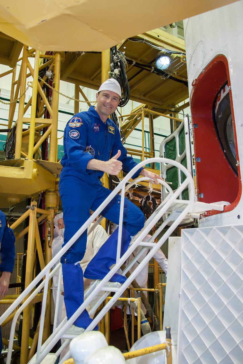 59-49-3: At the Baikonur Cosmodrome in Kazakhstan, Expedition 40/41 Flight Engineer Reid Wiseman of NASA poses for pictures as he boards the Soyuz TMA-13M spacecraft May 24 during the final fit check training dress rehearsal. Wiseman, Soyuz Commander Max Suraev of the Russian Federal Space Agency (Roscosmos) and Flight Engineer Alexander Gerst of the European Space Agency will launch May 29, Kazakh time, on the Soyuz TMA-13M spacecraft for a 5 ½ month mission on the International Space Station. NASA/Victor Zelentsov