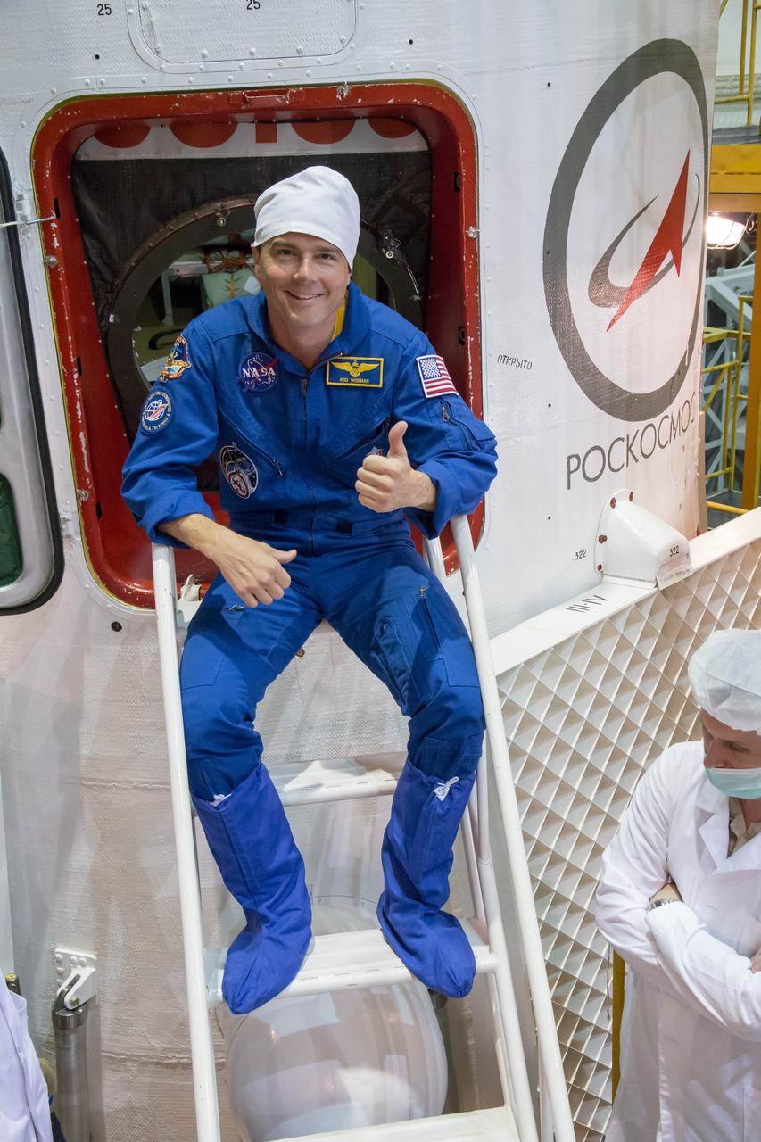 11-42-42-2: At the Baikonur Cosmodrome in Kazakhstan, Expedition 40/41 Flight Engineer Reid Wiseman of NASA poses for pictures as he boards the Soyuz TMA-13M spacecraft May 24 during the final fit check training dress rehearsal. Wiseman, Soyuz Commander Max Suraev of the Russian Federal Space Agency (Roscosmos) and Flight Engineer Alexander Gerst of the European Space Agency will launch May 29, Kazakh time, on the Soyuz TMA-13M spacecraft for a 5 ½ month mission on the International Space Station. NASA/Victor Zelentsov