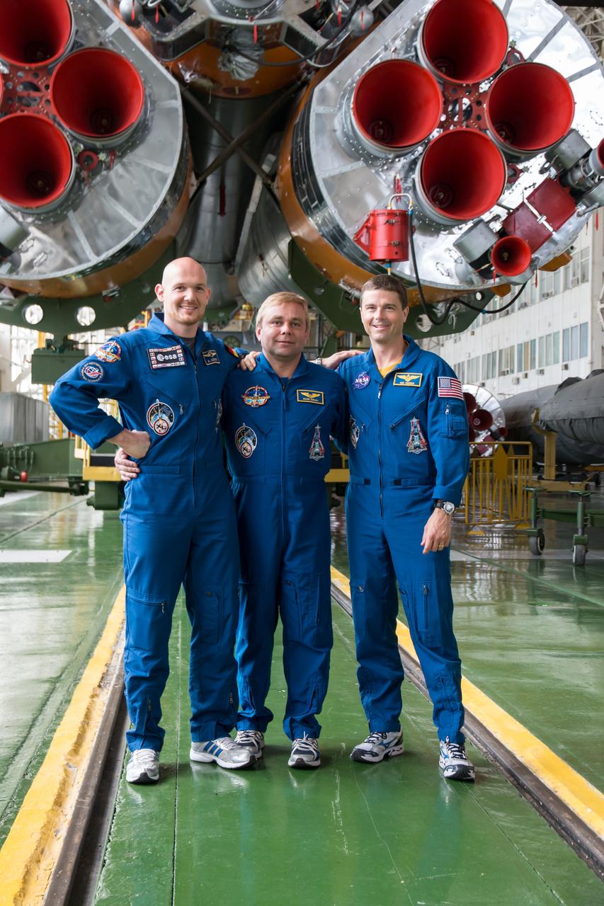 13-15-15-3: At the Baikonur Cosmodrome in Kazakhstan, Expedition 40/41 Flight Engineer Alexander Gerst of the European Space Agency (left), Soyuz Commander Max Suraev of the Russian Federal Space Agency (Roscosmos, center) and Flight Engineer Reid Wiseman of NASA (right) pose for pictures in front of the Soyuz booster rocket’s first stage engines May 24 during the final fit check training dress rehearsal. The trio will launch May 29, Kazakh time, on the Soyuz TMA-13M spacecraft for a 5 ½ month mission on the International Space Station. NASA/Victor Zelentsov