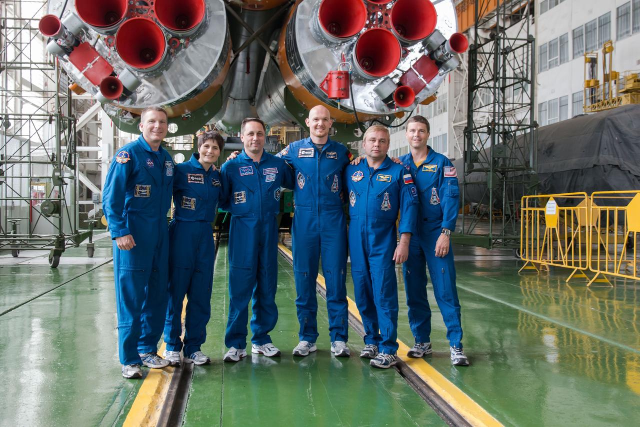 13-16-01-3:  At the Baikonur Cosmodrome in Kazakhstan, the Expedition 40/41 backup and prime crewmembers pose for pictures in front of the Soyuz booster rocket’s first stage engines May 24 during the final fit check training dress rehearsal. From left to right are backup crewmembers Terry Virts of NASA, Samantha Cristoforetti of the European Space Agency, Anton Shkaplerov of the Russian Federal Space Agency (Roscosmos), and prime crewmembers Flight Engineer Alexander Gerst of the European Space Agency, Soyuz Commander Max Suraev of Roscosmos and Flight Engineer Reid Wiseman of NASA. Gerst, Suraev and Wiseman will launch May 29, Kazakh time, on the Soyuz TMA-13M spacecraft for a 5 ½ month mission on the International Space Station.  NASA/Victor Zelentsov 