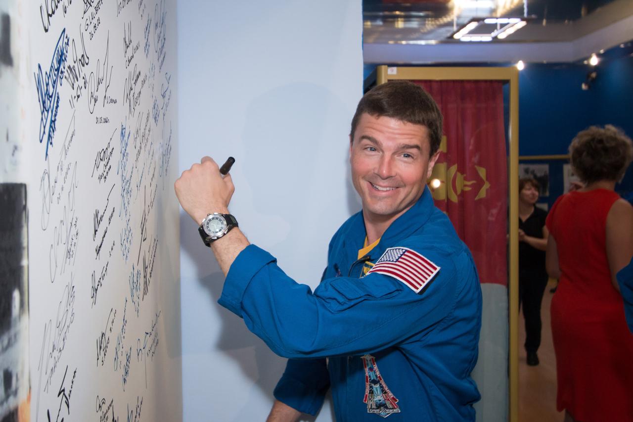 13-48-59-3:  Inside the Korolev Museum at the Baikonur Cosmodrome in Kazakhstan, Expedition 40/41 Flight Engineer Reid Wiseman of NASA signs his name to a wall mural bearing the picture of a Soyuz rocket launch May 24 during traditional pre-launch ceremonies. Wiseman, Soyuz Commander Max Suraev of the Russian Federal Space Agency (Roscosmos) and Flight Engineer Alexander Gerst of the European Space Agency will launch May 29, Kazakh time, on the Soyuz TMA-13M spacecraft for a 5 ½ month mission on the International Space Station.  NASA/Victor Zelentsov 