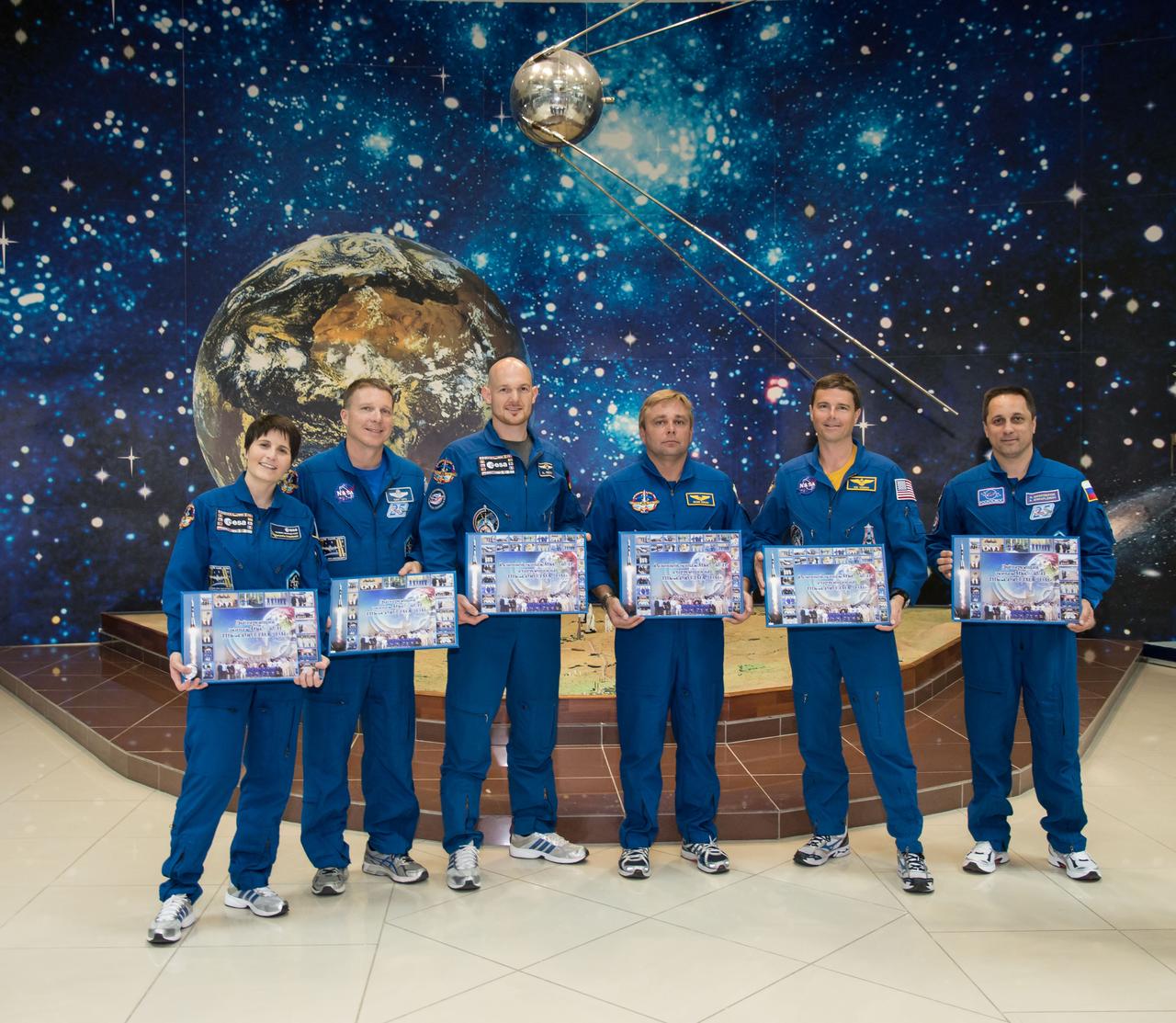 14-12-29:  Inside the Korolev Museum at the Baikonur Cosmodrome in Kazakhstan, the Expedition 40/41 prime and backup crewmembers display montages of space memorabilia photos that were presented to them May 24 during traditional pre-launch ceremonies. From left to right are backup crewmembers Samantha Cristoforetti of the European Space Agency and Terry Virts of NASA, prime crewmembers Alexander Gerst of the European Space Agency, Max Suraev of the Russian Federal Space Agency (Roscosmos) and Reid Wiseman of NASA, and backup crewmember Anton Shkaplerov of Roscosmos. Wiseman, Gerst and Suraev will launch May 29, Kazakh time, on the Soyuz TMA-13M spacecraft for a 5 ½ month mission on the International Space Station.  NASA/Victor Zelentsov 