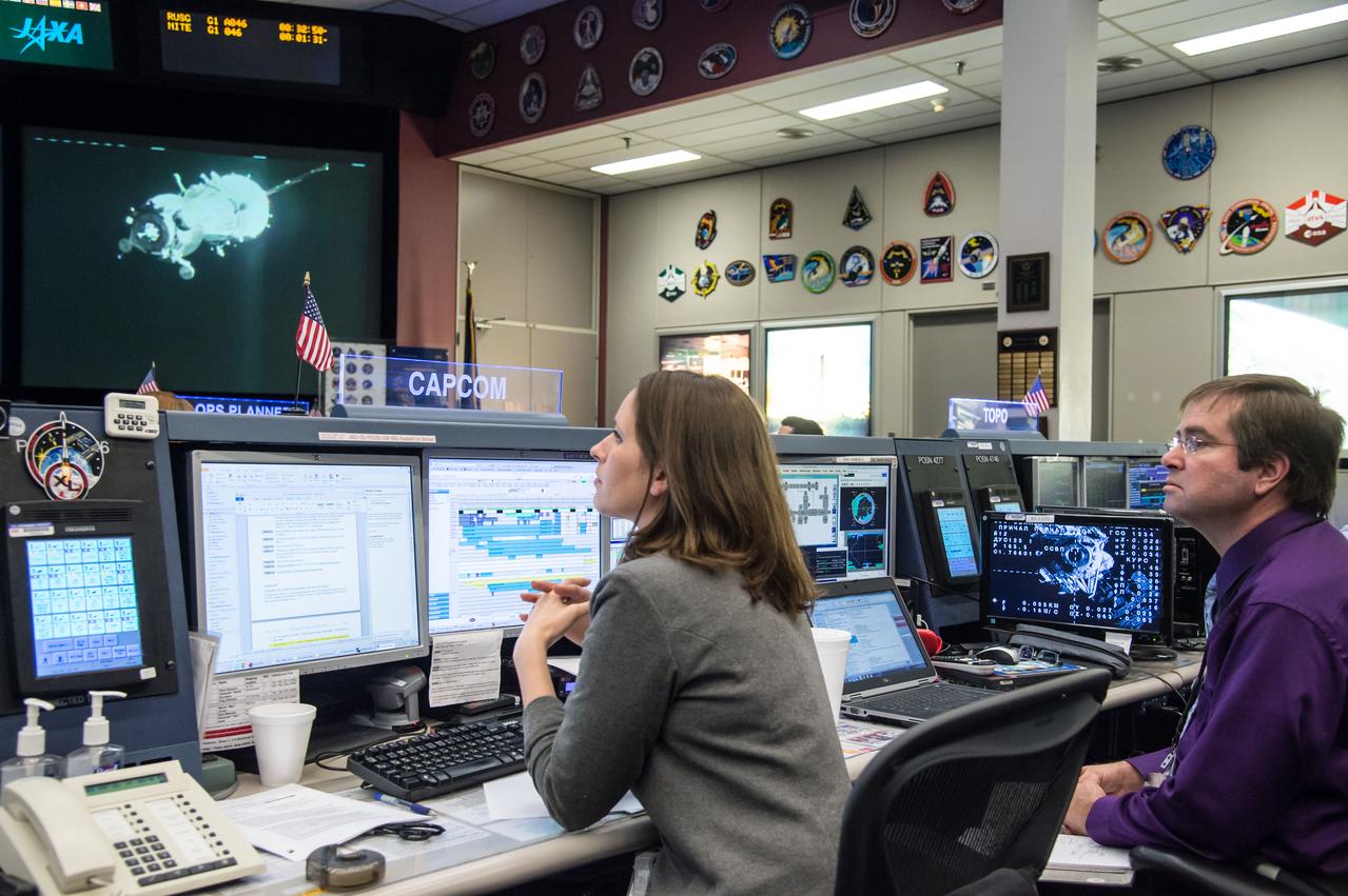 DATE: 5-28-14 LOCATION: Bldg 30, FCR-1 SUBJECT: ISS flight directors David Korth and Tomas Gonzales-Torres and controllers on console in FCR-1 during the docking of Expedition 40/41 Flight Engineer Reid Wiseman of NASA, Soyuz Commander Max Suraev of the Russian Federal Space Agency (Roscosmos) and Flight Engineer Alexander Gerst of the European Space Agency to the space station in a Soyuz spacecraft PHOTOGRAPHER: Lauren Harnett