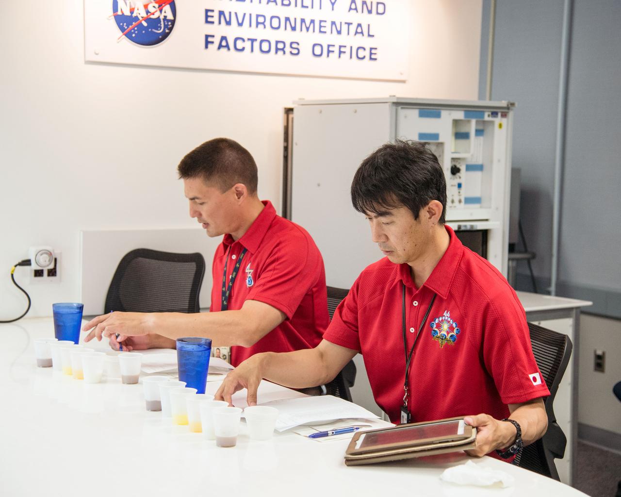 PHOTO DATE: 07-10-14 LOCATION: Bldg. 17, Room 1070 - Food Lab SUBJECT: Soyuz 43 (Expedition 44/45) crew members Kjell Lindgren and Kimiya Yui during Food Tasting #2. PHOTOGRAPHER: BILL STAFFORD