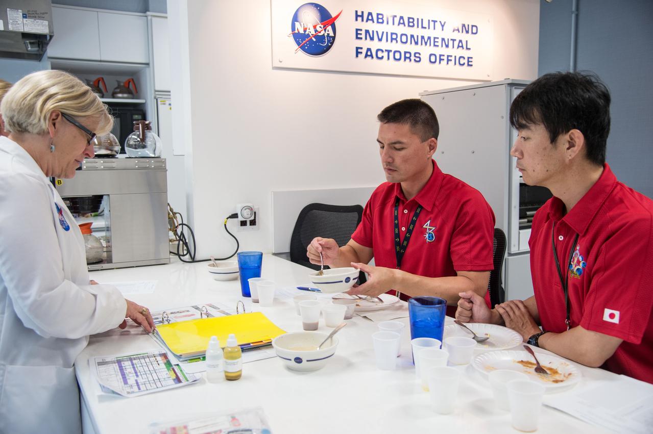 PHOTO DATE: 07-10-14 LOCATION: Bldg. 17, Room 1070 - Food Lab SUBJECT: Soyuz 43 (Expedition 44/45) crew members Kjell Lindgren and Kimiya Yui during Food Tasting #2. PHOTOGRAPHER: BILL STAFFORD