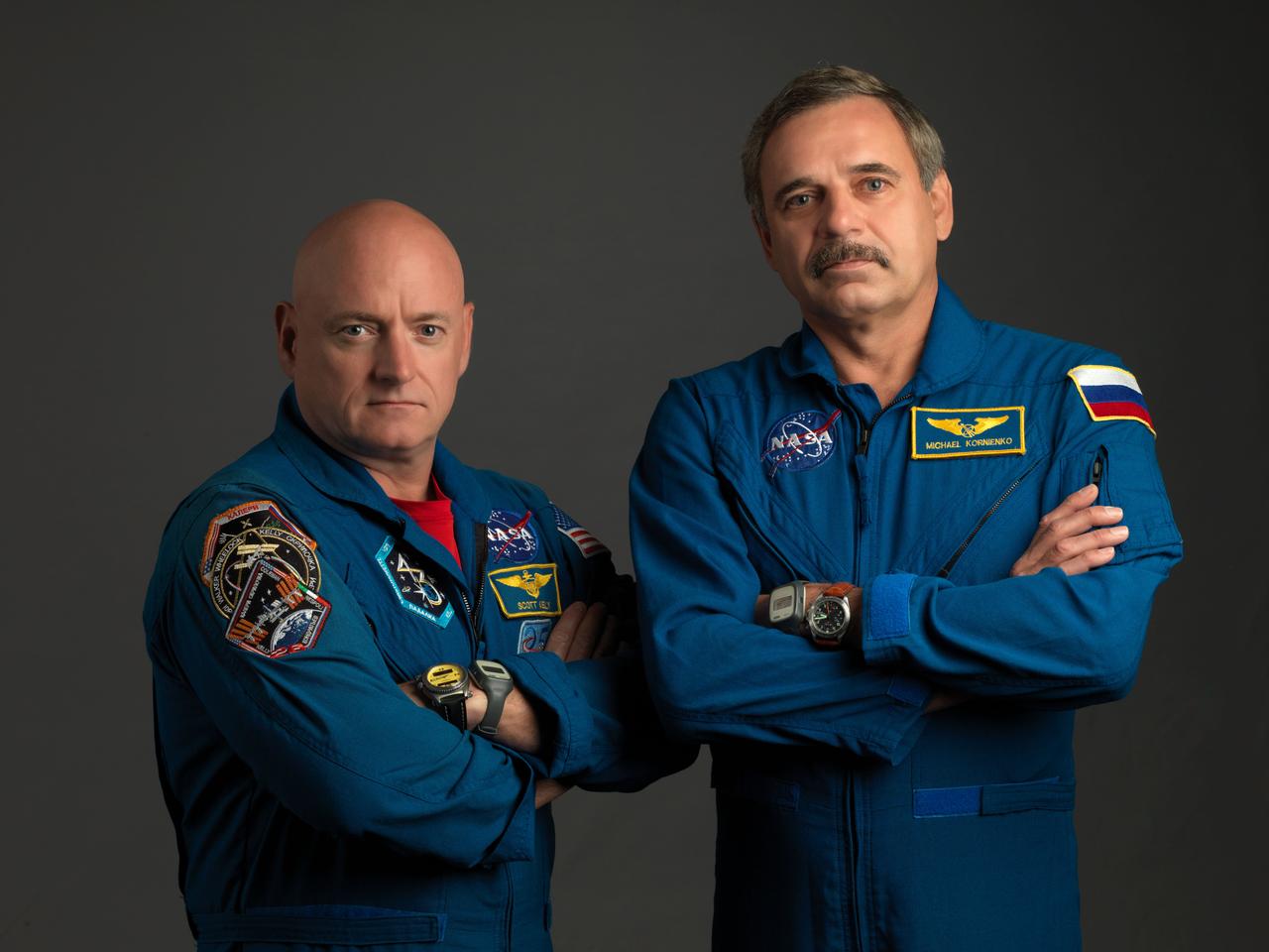 JSC2014-E-067735 (10 July 2014) --- NASA astronaut Scott Kelly (left), Expedition 43/44 flight engineer and Expedition 45/46 commander; and Russian cosmonaut Mikhail Kornienko, Expedition 43-46 flight engineer, take a break from training at NASA?s Johnson Space Center to pose for a portrait. Photo credit: NASA/Bill Stafford