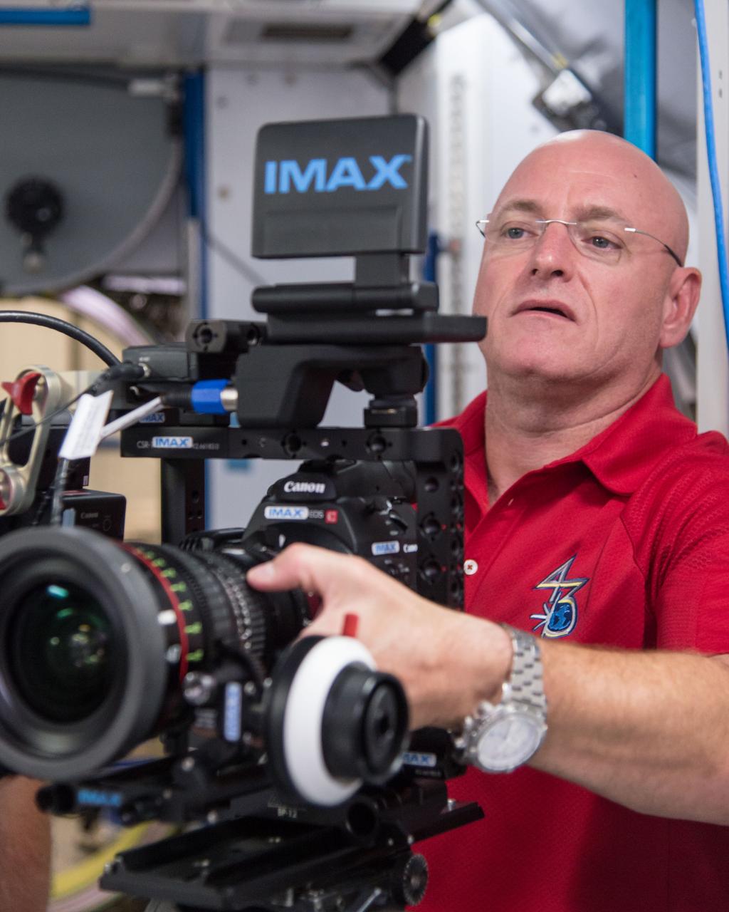 DATE: 8-5-14 LOCATION: Bldg 9, ISS mockups SUBJECT: Expedition (45/46) commander Scott Kelly during IMAX camera training with IMAX instructors and Mark Turner. PHOTOGRAPHER: Lauren Harnett