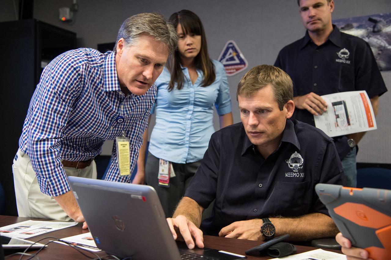 Date: 08-21-14 Location: Bldg 36, 131 Subject: ESA Astronaut Andreas Mogensen and NASA astronaut Randy Bresnik during NEEMO 19 communications training with instructors Marcum Reagan and Barbara Janoiko Photographer: James Blair