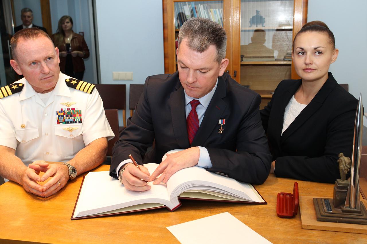 2329:  At the Gagarin Cosmonaut Training Center in Star City, Russia, Expedition 41/42 Soyuz Commander Alexander Samokutyaev of the Russian Federal Space Agency (Roscosmos, center) signs a welcome book at the Gagarin Museum Sept. 5 in a traditional ceremony as his crewmates, NASA’s Barry Wilmore (left) and Elena Serova of Roscosmos (right) look on. The trio will launch from the Baikonur Cosmodrome in Kazakhstan on Sept. 26, Kazakh time, in their Soyuz TMA-14M spacecraft for a 5 ½ month mission on the International Space Station. Serova will become the fourth Russian woman to fly in space and the first Russian woman to conduct a long duration mission on the station.  NASA/Stephanie Stoll 