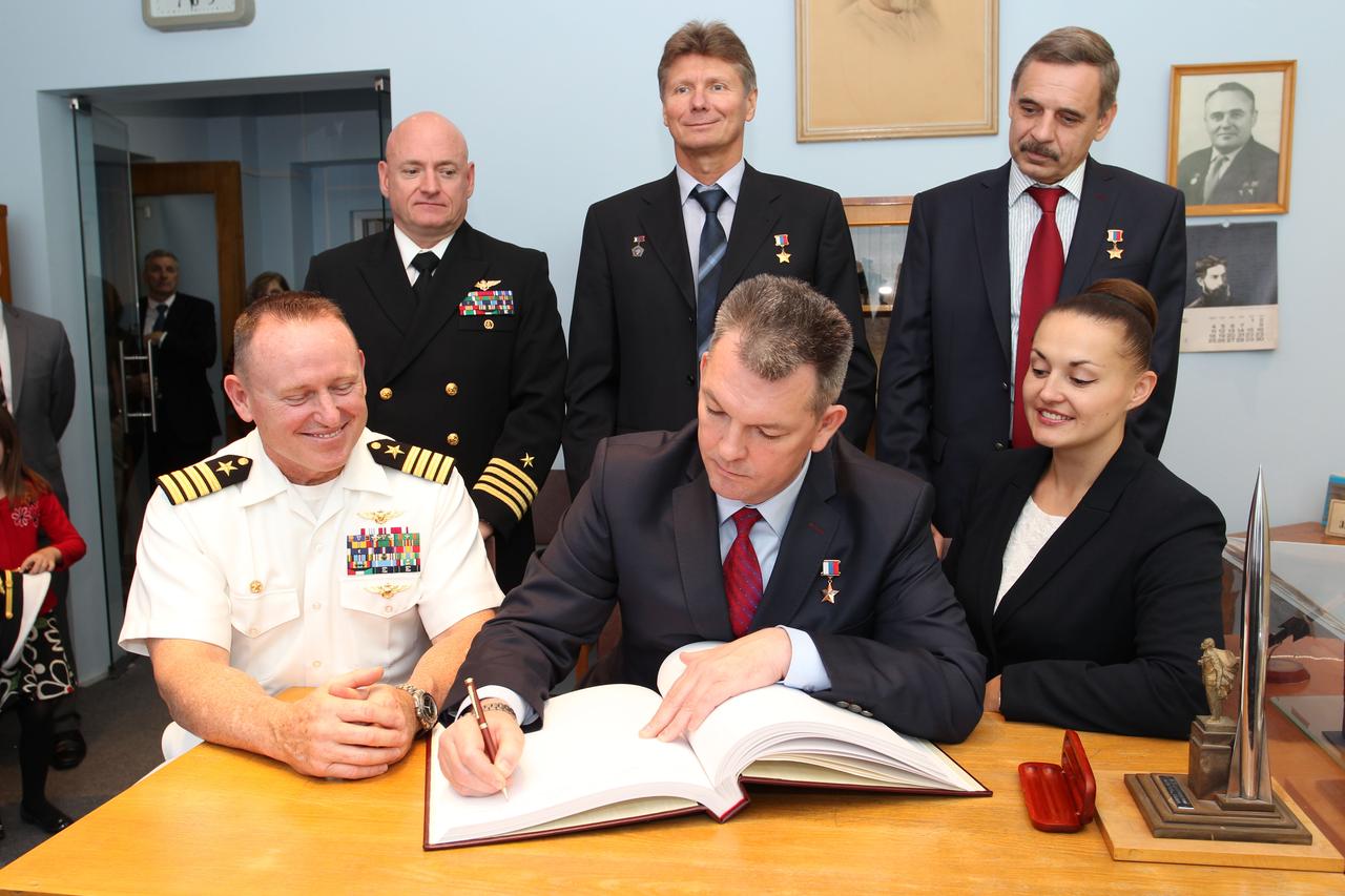 2346:  At the Gagarin Cosmonaut Training Center in Star City, Russia, Expedition 41/42 Soyuz Commander Alexander Samokutyaev of the Russian Federal Space Agency (Roscosmos, front row, center) signs a welcome book at the Gagarin Museum Sept. 5 in a traditional ceremony as his crewmates, NASA’s Barry Wilmore (front row, left) and Elena Serova of Roscosmos (front row, right) look on. In the back row are their backups, NASA’s Scott Kelly (back row, left), Gennady Padalka of Roscosmos (back row, center) and Mikhail Kornienko of Roscosmos (back row, right). Wilmore, Samokutyaev and Serova will launch from the Baikonur Cosmodrome in Kazakhstan on Sept. 26, Kazakh time, in their Soyuz TMA-14M spacecraft for a 5 ½ month mission on the International Space Station. Serova will become the fourth Russian woman to fly in space and the first Russian woman to conduct a long duration mission on the station. Kelly and Kornienko will launch in March 2015 to spend a full year on the complex.  NASA/Stephanie Stoll 