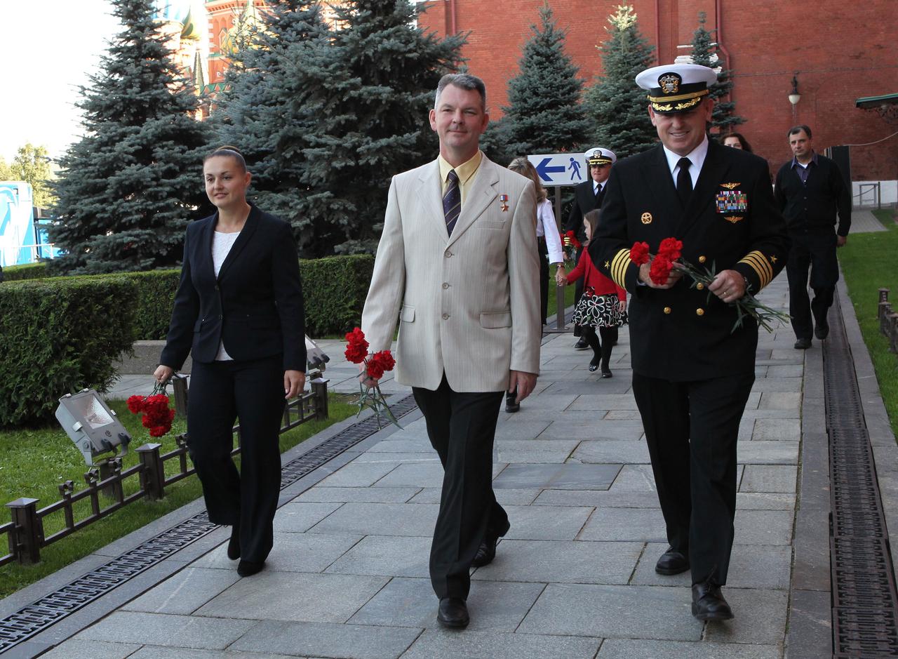 2529a:  Expedition 41/42 Flight Engineer Elena Serova of the Russian Federal Space Agency (Roscosmos, left), Soyuz Commander Alexander Samokutyaev of Roscosmos (center) and NASA Flight Engineer Barry Wilmore (right) walk along the Kremlin Wall at Moscow’s Red Square Sept. 5 where they laid flowers at the sites where Russian space icons are interred in a traditional ceremony. The trio will launch from the Baikonur Cosmodrome in Kazakhstan on Sept. 26, Kazakh time, in their Soyuz TMA-14M spacecraft for a 5 ½ month mission on the International Space Station. Serova will become the fourth Russian woman to fly in space and the first Russian woman to conduct a long duration mission on the station.   NASA/Stephanie Stoll 