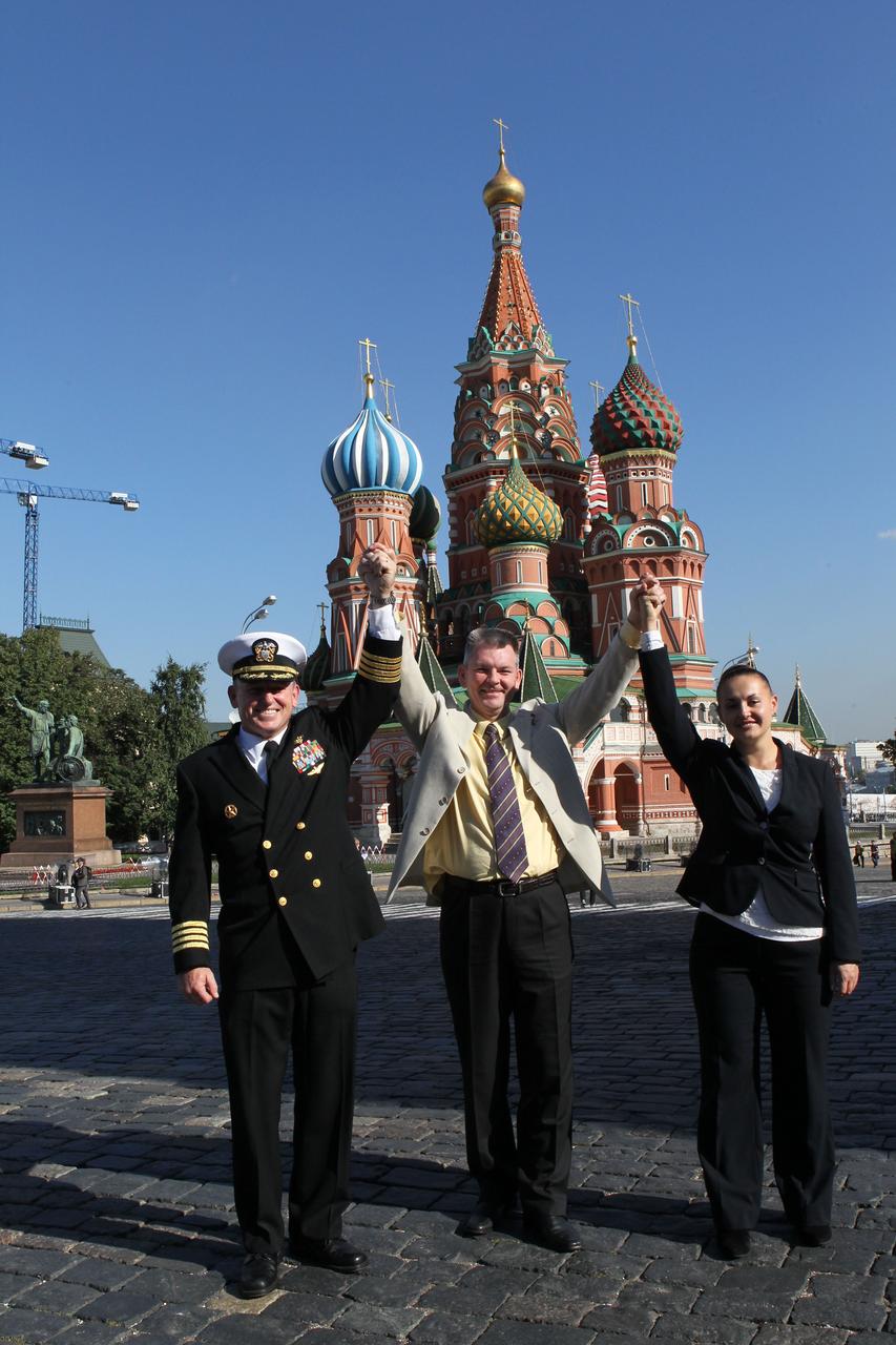 2734:  Expedition 41/42 Flight Engineer Barry Wilmore of NASA (left), Soyuz Commander Alexander Samokutyaev of the Russian Federal Space Agency (Roscosmos, center) and Elena Serova of Roscosmos (right) hoist arms in a display of unity in front of St. Basil’s Cathedral in Moscow’s Red Square Sept. 5 where they laid flowers at the site where Russian space icons are interred in a traditional ceremony. The trio will launch from the Baikonur Cosmodrome in Kazakhstan on Sept. 26, Kazakh time, in their Soyuz TMA-14M spacecraft for a 5 ½ month mission on the International Space Station. Serova will become the fourth Russian woman to fly in space and the first Russian woman to conduct a long duration mission on the station.   NASA/Stephanie Stoll 