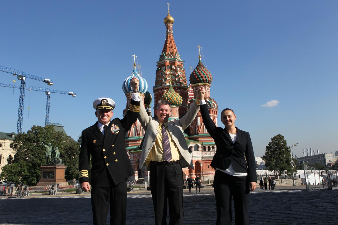 2741:  Expedition 41/42 Flight Engineer Barry Wilmore of NASA (left), Soyuz Commander Alexander Samokutyaev of the Russian Federal Space Agency (Roscosmos, center) and Elena Serova of Roscosmos (right) hoist arms in a display of unity in front of St. Basil’s Cathedral in Moscow’s Red Square Sept. 5 where they laid flowers at the site where Russian space icons are interred in a traditional ceremony. The trio will launch from the Baikonur Cosmodrome in Kazakhstan on Sept. 26, Kazakh time, in their Soyuz TMA-14M spacecraft for a 5 ½ month mission on the International Space Station. Serova will become the fourth Russian woman to fly in space and the first Russian woman to conduct a long duration mission on the station.   NASA/Stephanie Stoll 