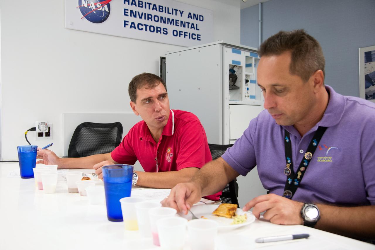 Date: 09-10-14 Location: Bldg 17, Food Lab Subject: Soyuz 44 crew member and cosmonauts Sergei Volkov and Anton Shkaplerov during food tasting in JSC Food Lab Photographer: James Blair