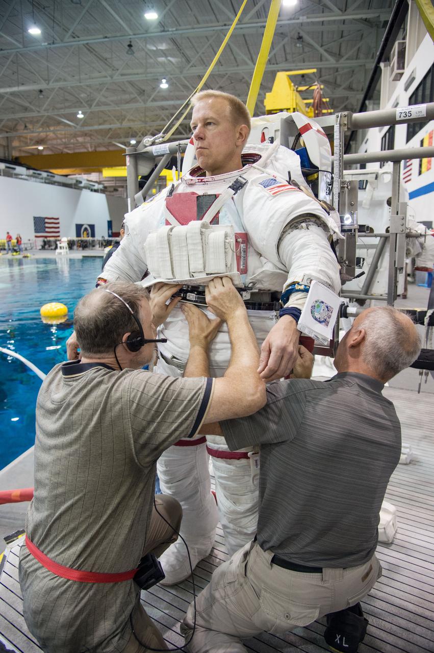 European Astronaut Tim Peake of ESA during ISS EVA MAINT 3 NBL Training with Astronaut Tim Kopra and instructor Sandy Moore. Photo Date: September 10, 2014. Location: NBL - Pool Topside. Photographer: Robert Markowitz